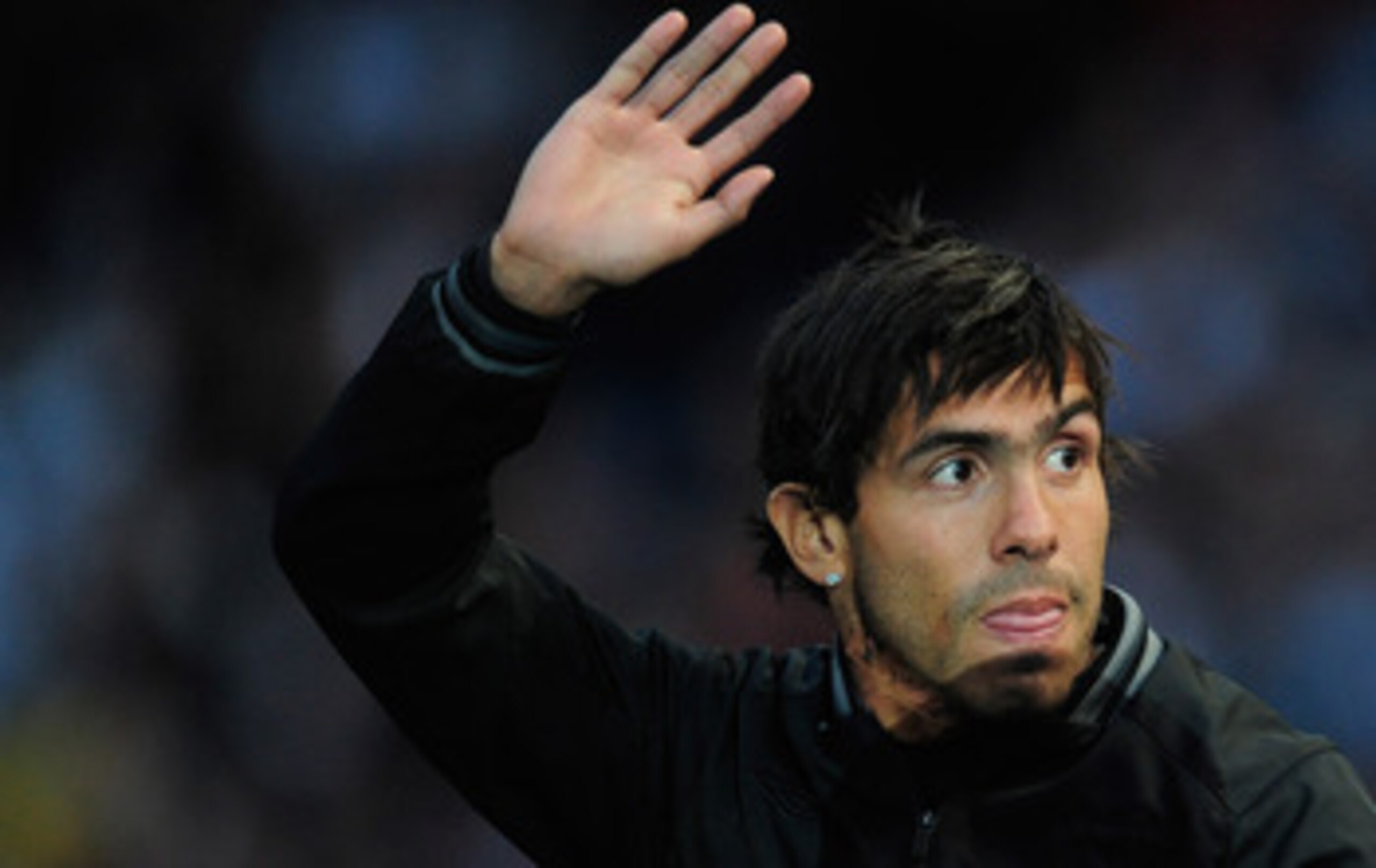 MANCHESTER, ENGLAND - MAY 23:  Carlos Tevez of Manchester City waves to the fans during the Manchester City FA Cup Winners Parade at the City of Manchester stadium on May 23, 2011 in Manchester, United Kingdom.  (Photo by Jamie McDonald/Getty Images)
