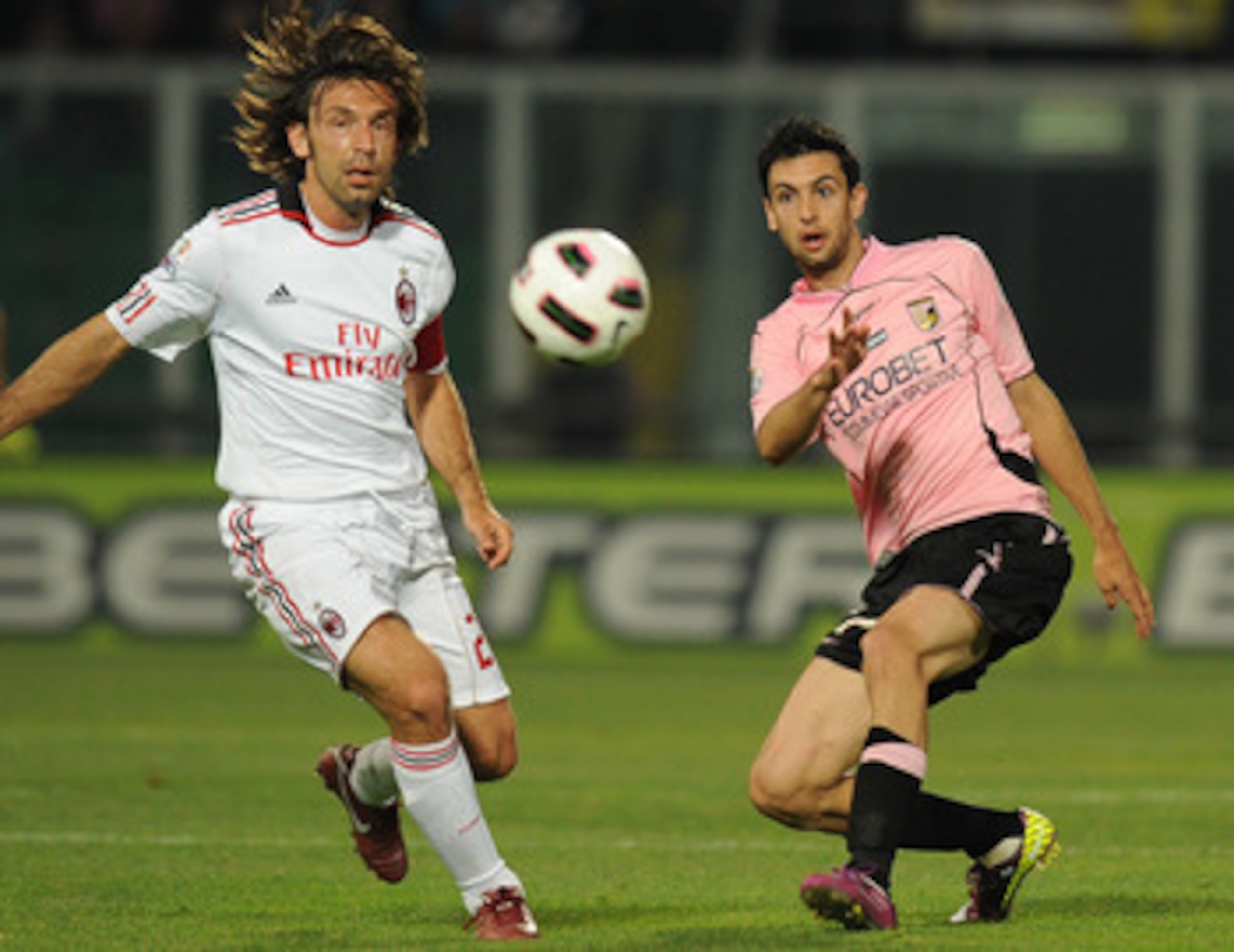 PALERMO, ITALY - MAY 10:  Javier Pastore (R) of Palermo and Andrea Pirlo of Palermo compete for the ball during the Tim Cup between US Citta di Palermo and AC Milan at Stadio Renzo Barbera on May 10, 2011 in Palermo, Italy.  (Photo by Tullio M. Puglia/Get