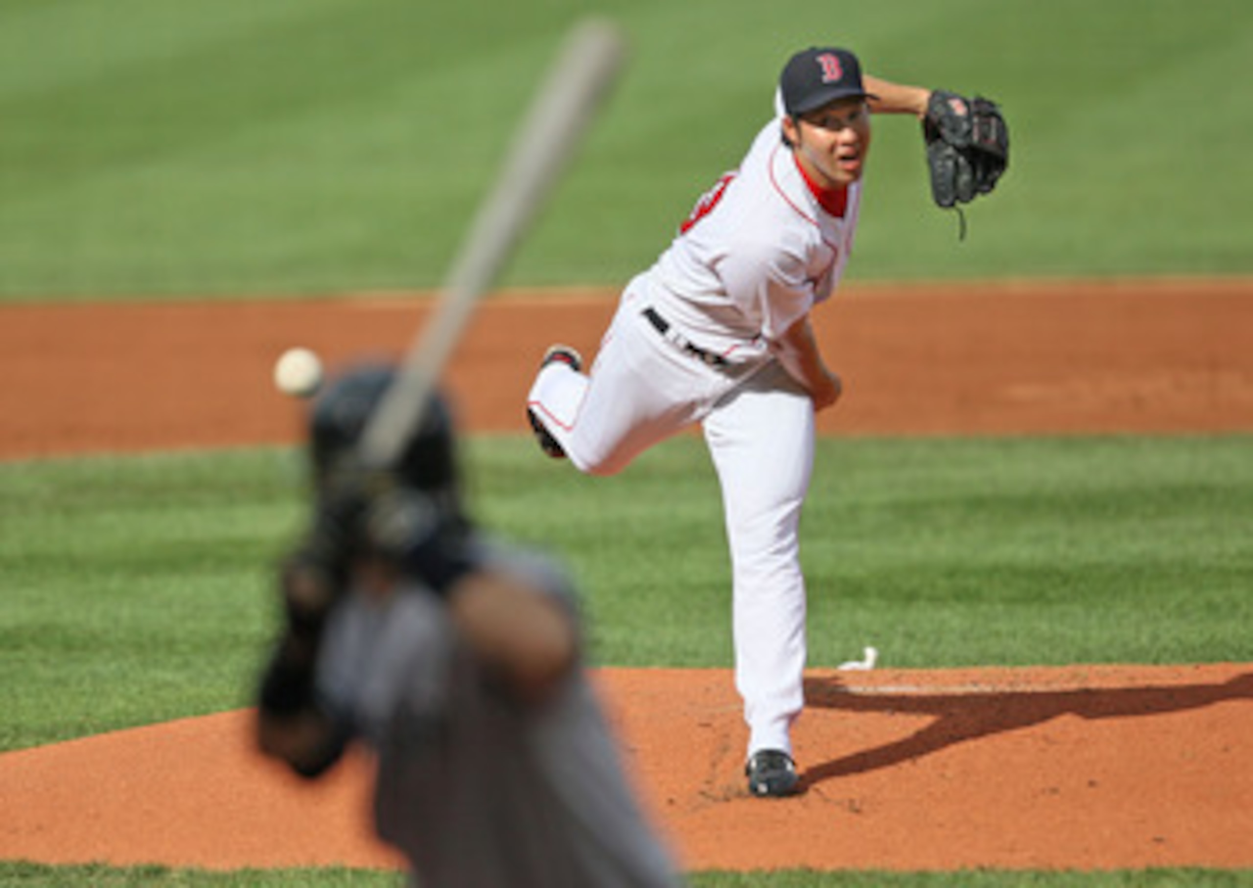 BOSTON - AUGUST 22:  Junichi Tazawa #63 of the Boston Red Sox throws against the New York Yankees at Fenway Park on August 22, 2009 in Boston, Massachusetts. (Photo by Jim Rogash/Getty Images)