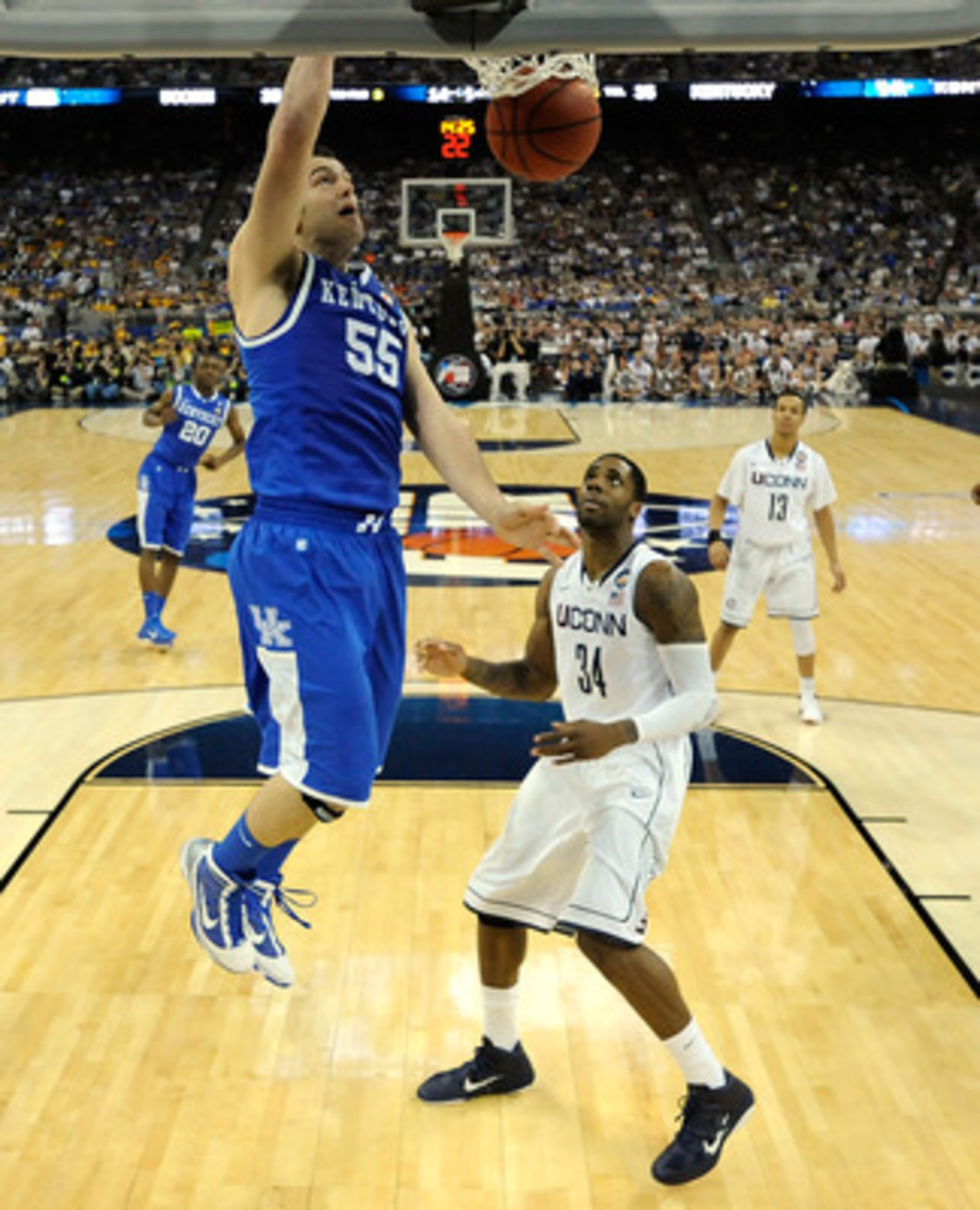 HOUSTON, TX - APRIL 02:  Josh Harrellson #55 of the Kentucky Wildcats dunks the ball against Alex Oriakhi #34 of the Connecticut Huskies during the National Semifinal game of the 2011 NCAA Division I Men's Basketball Championship at Reliant Stadium on Apr