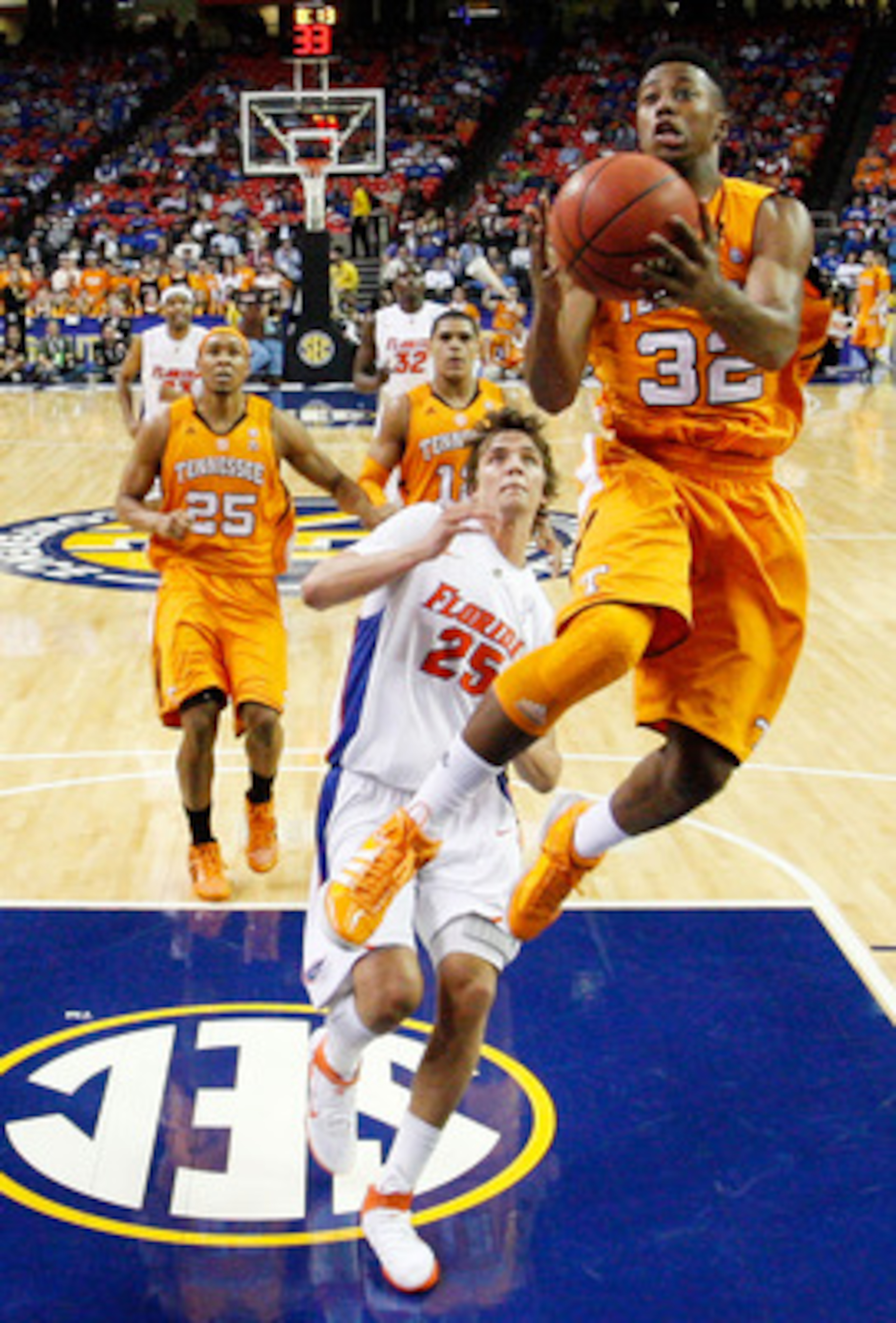 ATLANTA, GA - MARCH 11:  Scotty Hopson #32 of the Tennessee Volunteers shoots infront of Chandler Parsons #25 of the Florida Gators during the quarterfinals of the SEC Men's Basketball Tournament at Georgia Dome on March 11, 2011 in Atlanta, Georgia.  (Ph