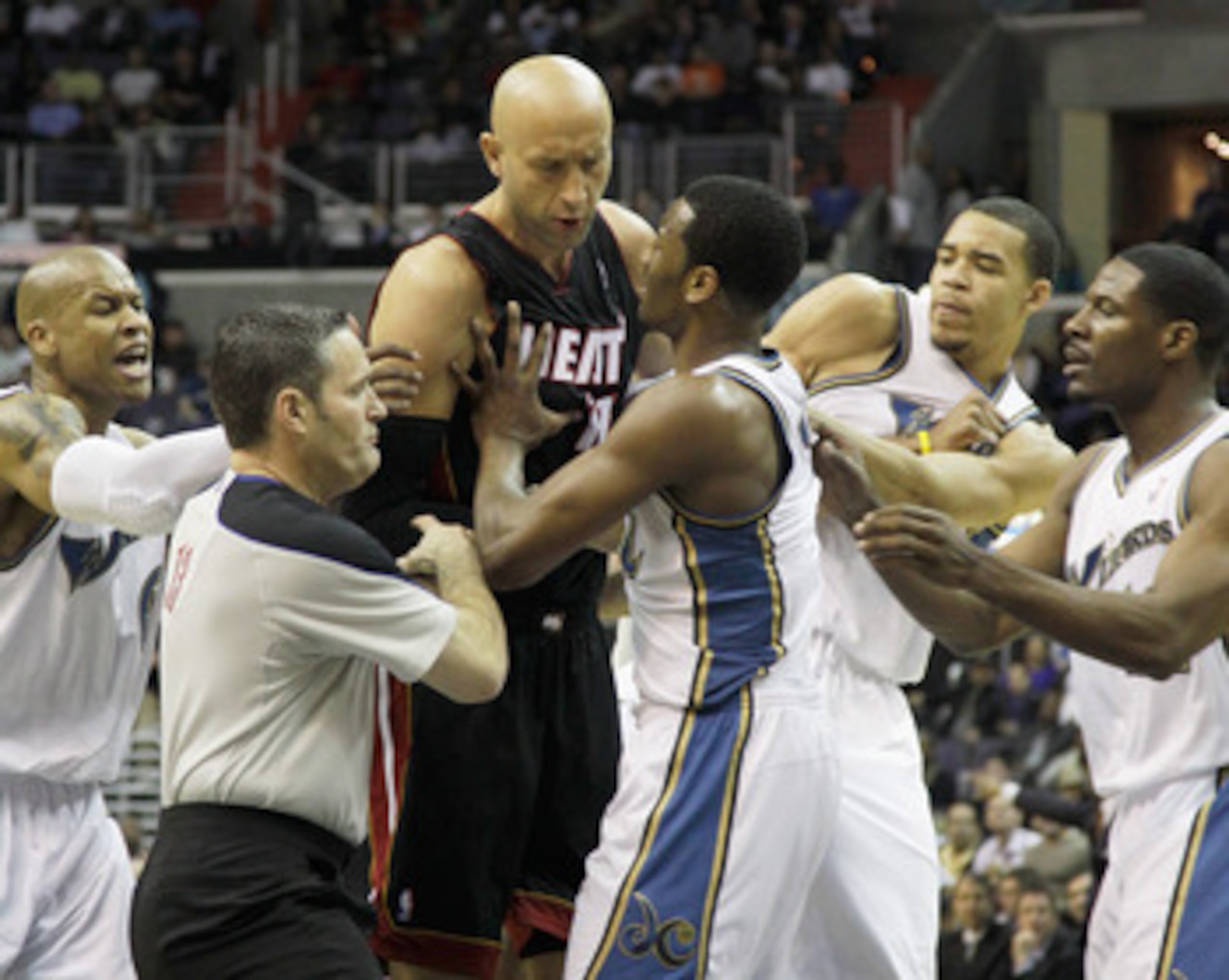 WASHINGTON, DC - MARCH 30: Zydrunas Ilgauskas #11 of the Miami Heat (C) and John Wall #2 of the Washington Wizards (R) are restrained by referee Monty McCutchen #13 (L) during the first half at the Verizon Center on March 30, 2011 in Washington, DC. Ilgau WASHINGTON, DC - MARCH 30: Zydrunas Ilgauskas #11 of the Miami Heat (C) and John Wall #2 of the Washington Wizards (R) are restrained by referee Monty McCutchen #13 (L) during the first half at the Verizon Center on March 30, 2011 in Washington, DC. Ilgau