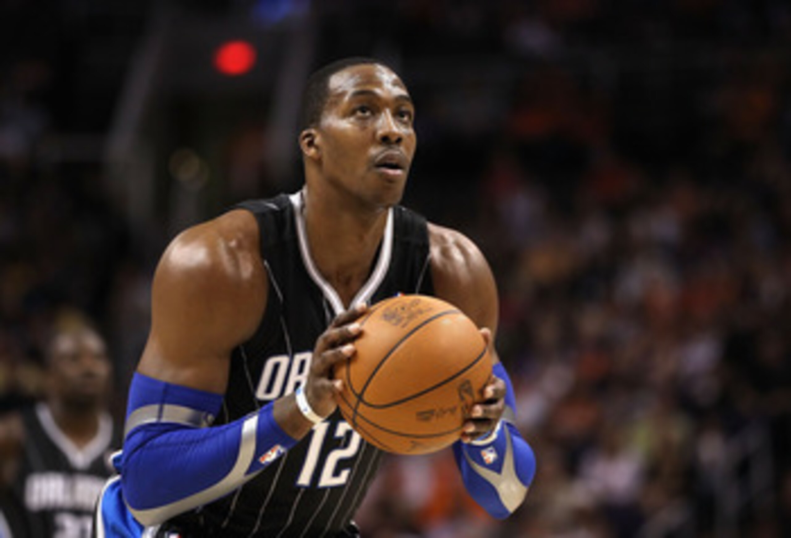 PHOENIX, AZ - MARCH 13:  Dwight Howard #12 of the Orlando Magic shoots a free throw shot against the Phoenix Suns during the NBA game at US Airways Center on March 13, 2011 in Phoenix, Arizona.  NOTE TO USER: User expressly acknowledges and agrees that, b
