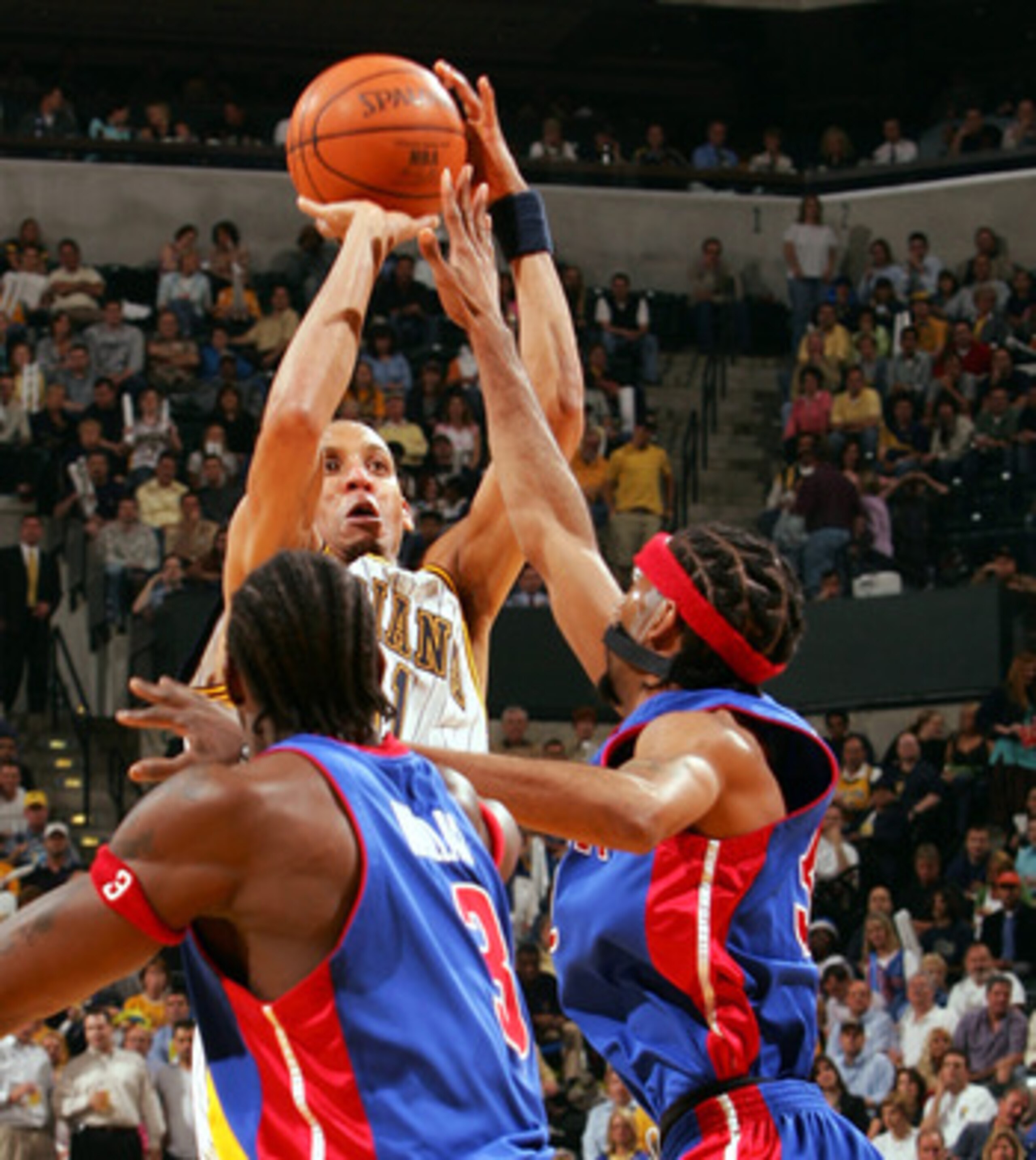 INDIANAPOLIS - MAY 19:  Reggie Miller #31 of the Indiana Pacers takes a shot as Ben Wallace #3 and Richard Hamilton #32 of the Detroit Pistons defend in Game six of the Eastern Conference Semifinals during the 2005 NBA Playoffs on May 19, 2005 at Conseco 