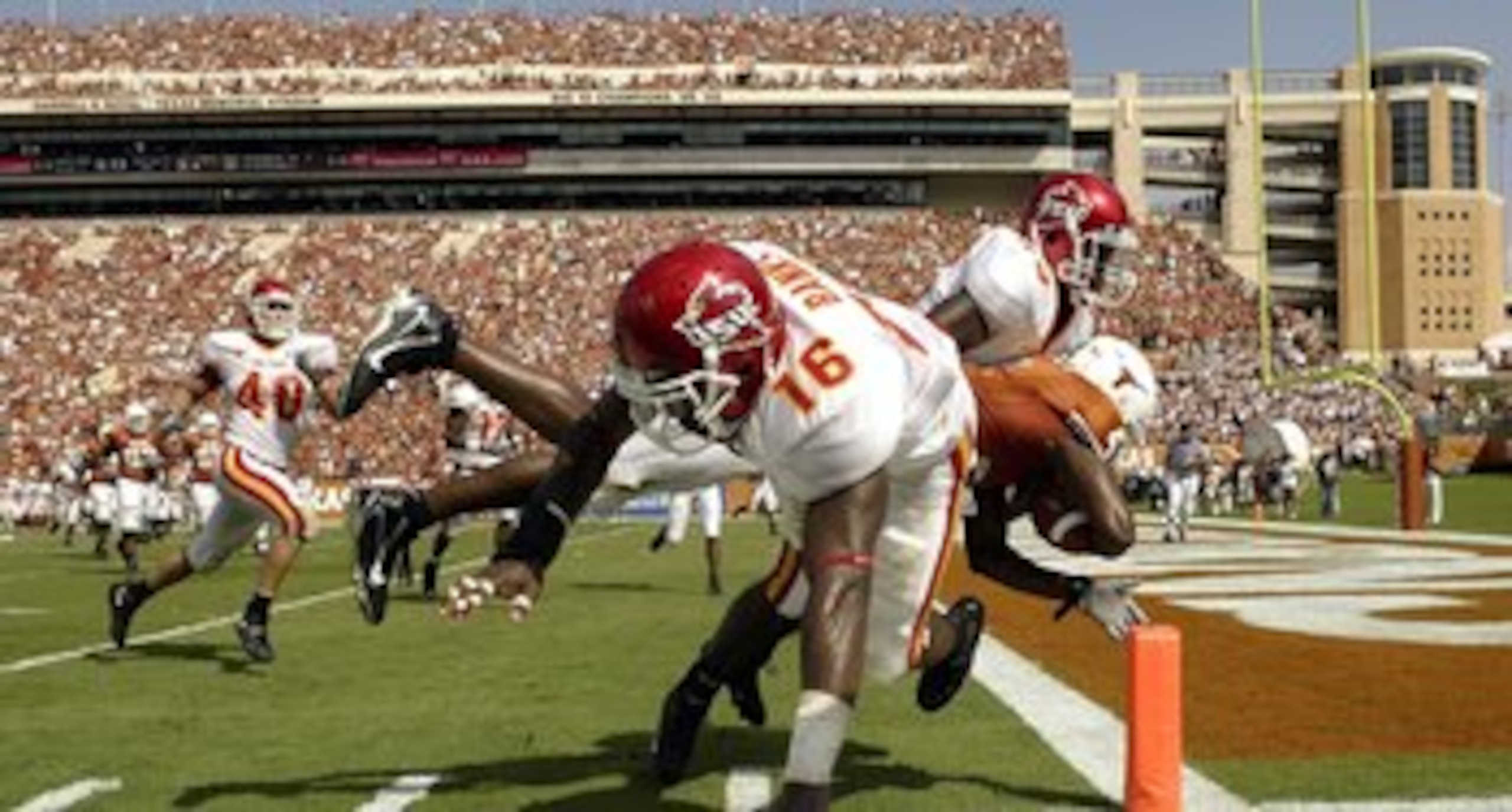 AUSTIN, TX - SEPTEMBER 23:  Wide receiver Limas Sweed #4 of the Texas Longhorns scores a touchdown while tackled by Fred Garrin #43 and Jon Banks #16 of  the Iowa State Cyclones on September 23, 2006 at Texas Memorial Stadium in Austin, Texas.  (Photo by