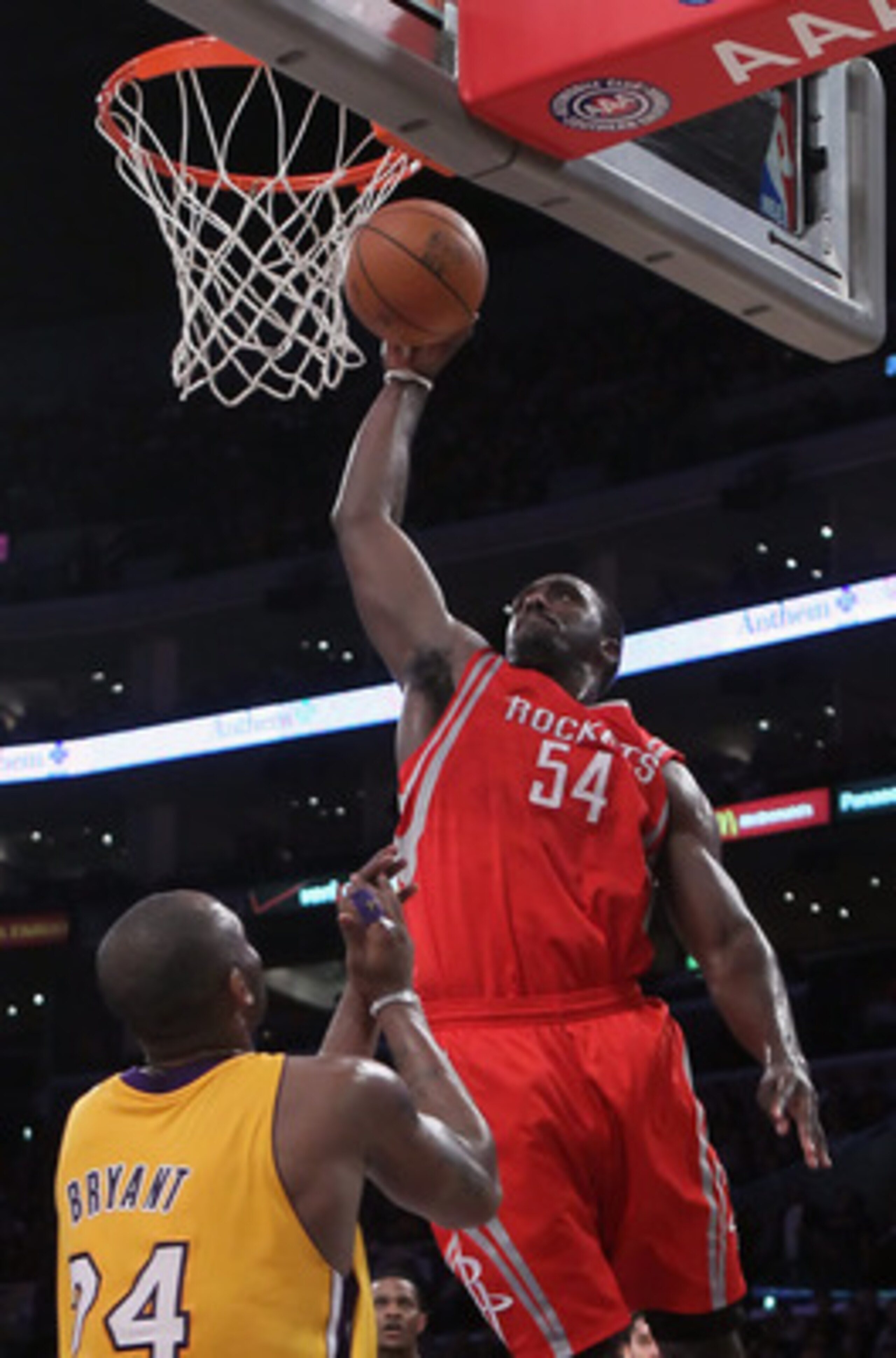 LOS ANGELES, CA - FEBRUARY 01:  Patrick Patterson #54 of the Houston Rockets drives over Kobe Bryant #24 of the Los Angeles Lakers for a dunk in the first half at Staples Center on February 1, 2011 in Los Angeles, California. NOTE TO USER: User expressly