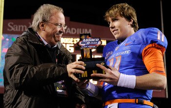 LAS VEGAS, NV - DECEMBER 22: MAACO President Dave Lapps (L) gives the most valuable player trophy to quarterback Kellen Moore #11 of the Boise State Broncos after the team's 26-3 victory over the Utah Utes in the MAACO Bowl Las Vegas at Sam Boyd Stadium LAS VEGAS, NV - DECEMBER 22: MAACO President Dave Lapps (L) gives the most valuable player trophy to quarterback Kellen Moore #11 of the Boise State Broncos after the team's 26-3 victory over the Utah Utes in the MAACO Bowl Las Vegas at Sam Boyd Stadium