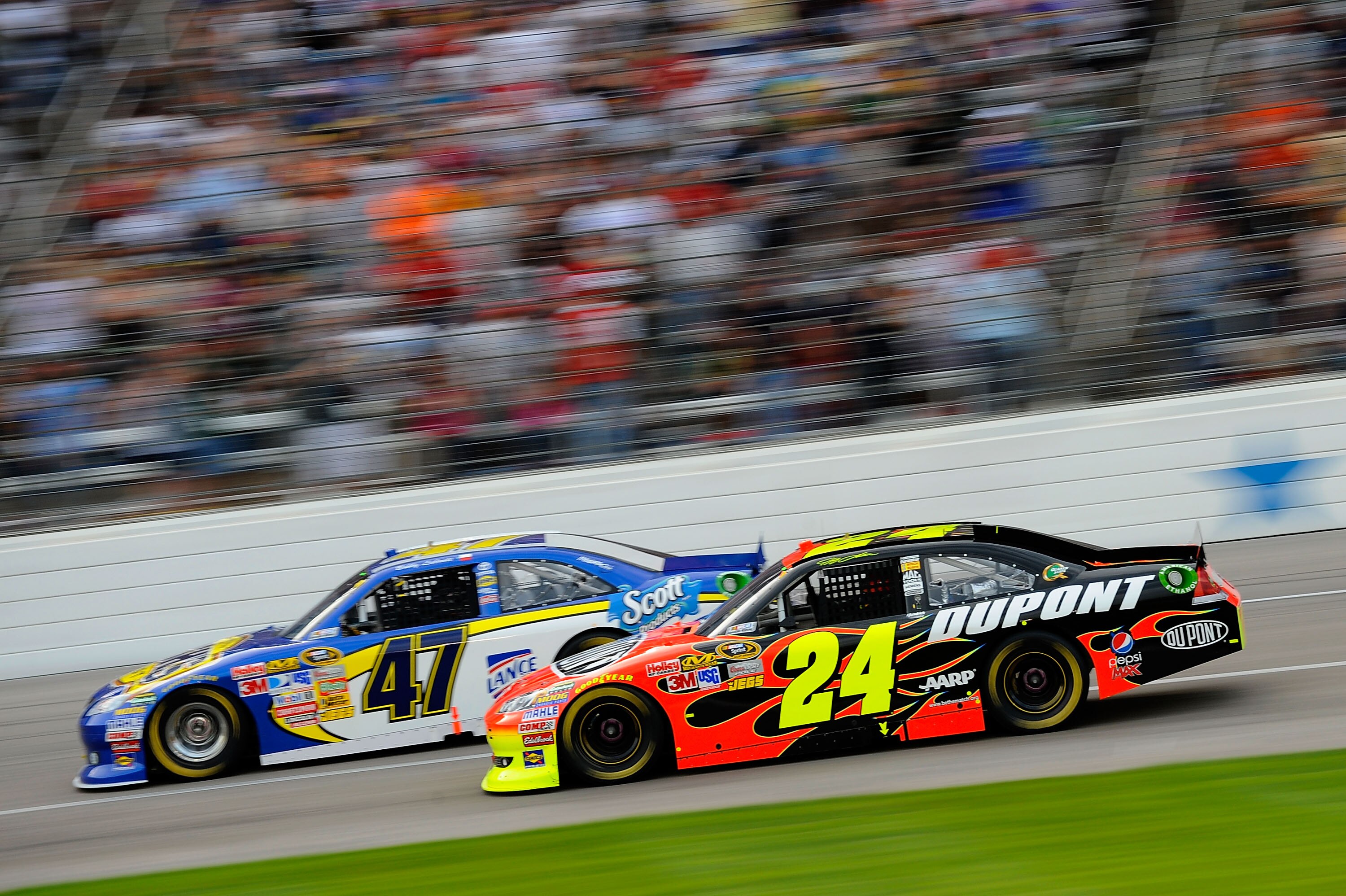 FORT WORTH, TX - APRIL 09:  Bobby Labonte, driver of the #47 Bush's Baked Beans Toyota, races Jeff Gordon, driver of the #24 DuPont Chevrolet, during the NASCAR Sprint Cup Series Samsung Mobile 500 at Texas Motor Speedway on April 9, 2011 in Fort Worth, T