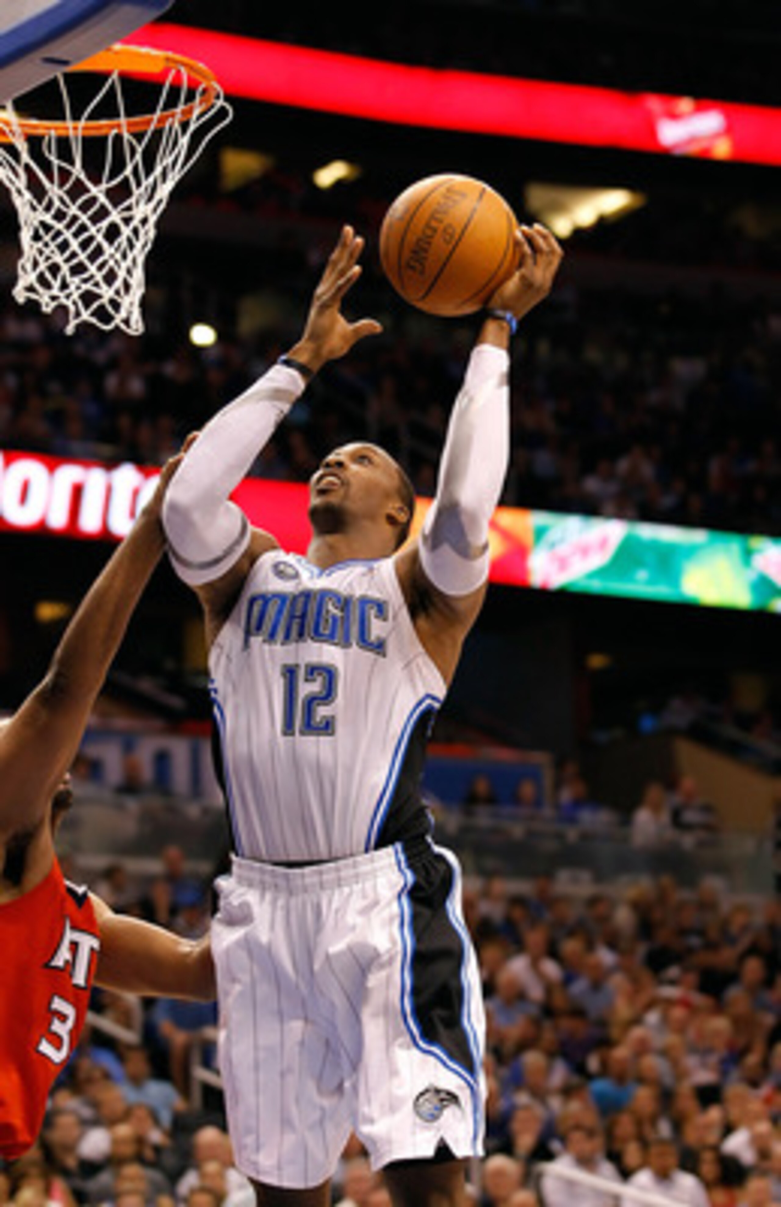 ORLANDO, FL - APRIL 16:  Dwight Howard #12 of the Orlando Magic lays the ball up against the Atlanta Hawks during Game One of the Eastern Conference Quarterfinals of the 2011 NBA Playoffs on April 16, 2011 at the Amway Arena in Orlando, Florida.  NOTE TO