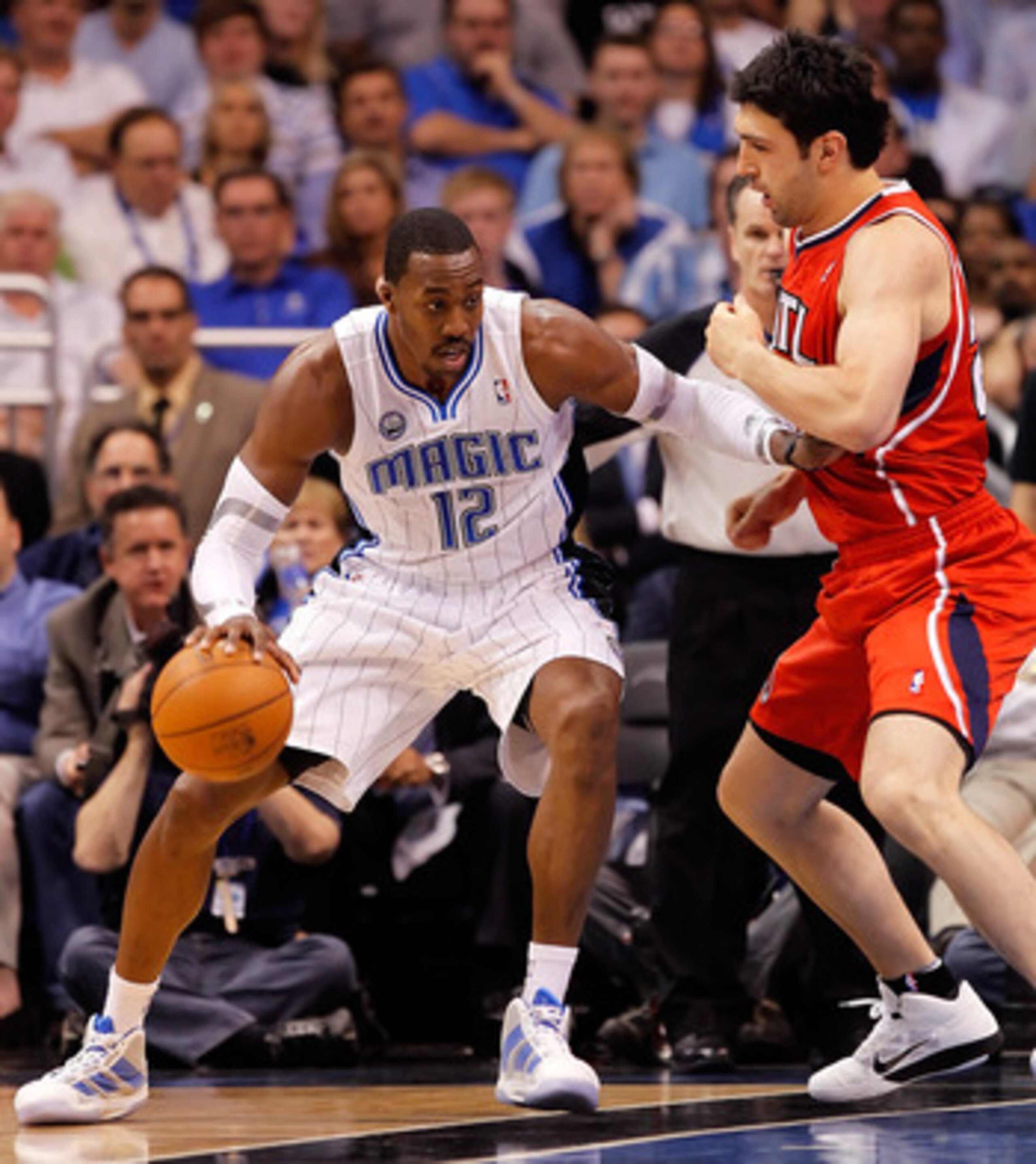 ORLANDO, FL - APRIL 19:  Dwight Howard #12 of the Orlando Magic drives as Zaza Pachulia #27 of the Atlanta Hawks defends during Game Two of the Eastern Conference Quarterfinals of the 2011 NBA Playoffs on April 19, 2011 at the Amway Arena in Orlando, Flor