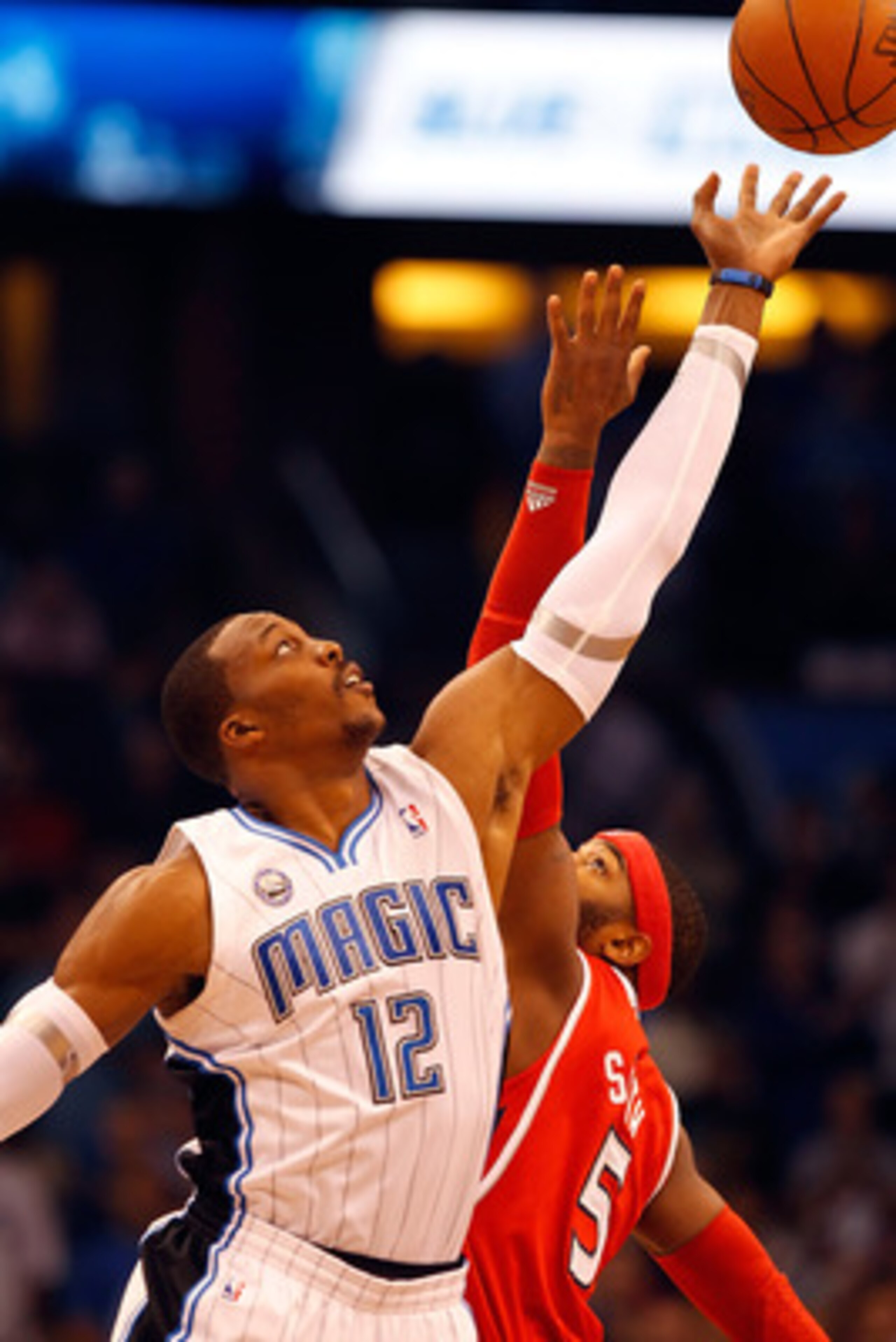 ORLANDO, FL - APRIL 19:  Dwight Howard #12 of the Orlando Magic wins the opening tipoff over Josh Smith of the Atlanta Hawks during Game Two of the Eastern Conference Quarterfinals of the 2011 NBA Playoffs on April 19, 2011 at the Amway Arena in Orlando,