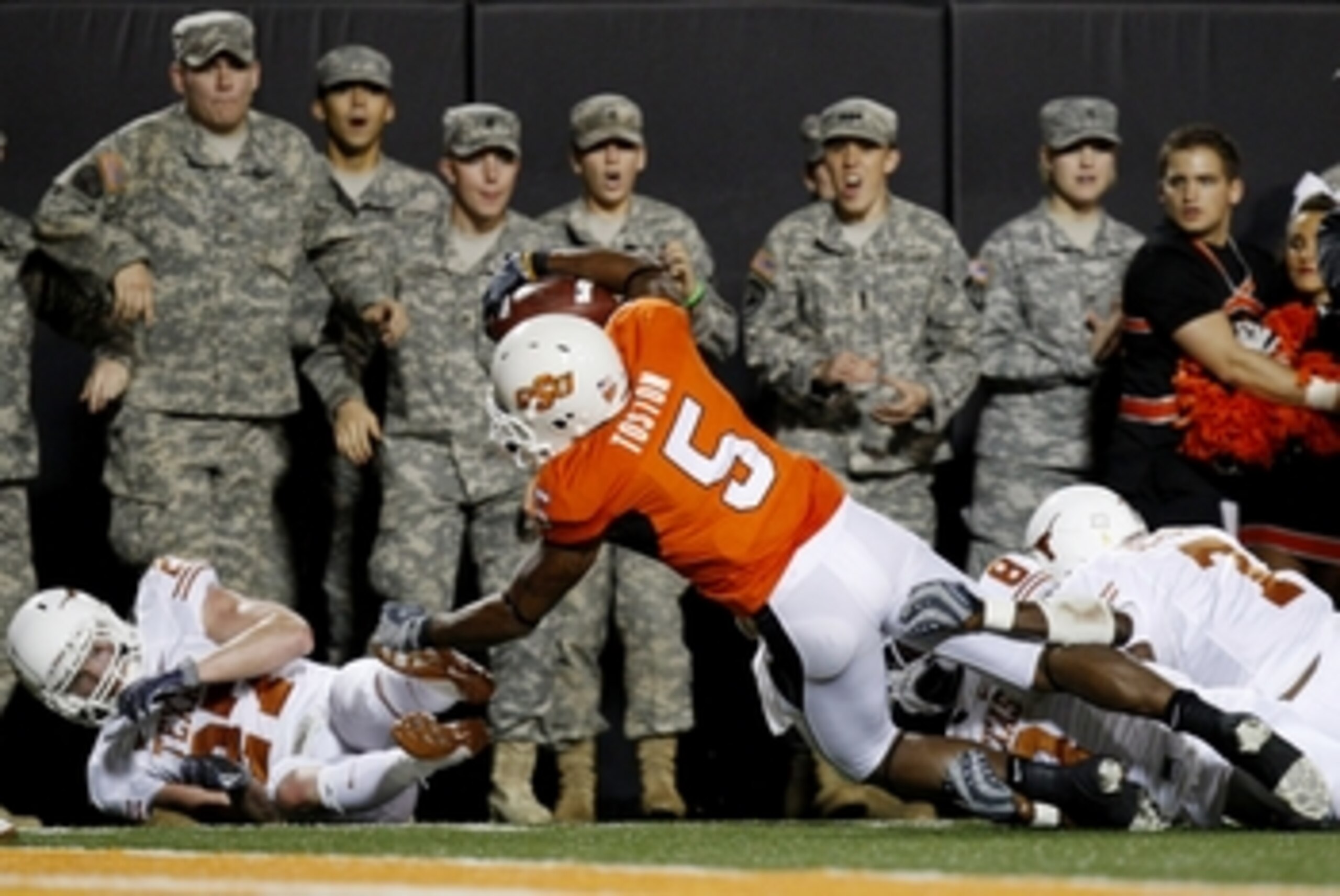 STILLWATER, OK - OCTOBER 31:  Running back Keith Toston #5 of the Oklahoma State Cowboys completes a pass to the one yard line during the second quarter of the game against the Texas Longhorns at Boone Pickens Stadium on October 31, 2009 in Stillwater, Ok
