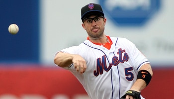 PORT ST. LUCIE, FL - FEBRUARY 26:  Third baseman David Wright #5 throws against the Atlanta Braves at Digital Domain Park on February 26, 2011 in Port St. Lucie, Florida.  (Photo by Marc Serota/Getty Images)