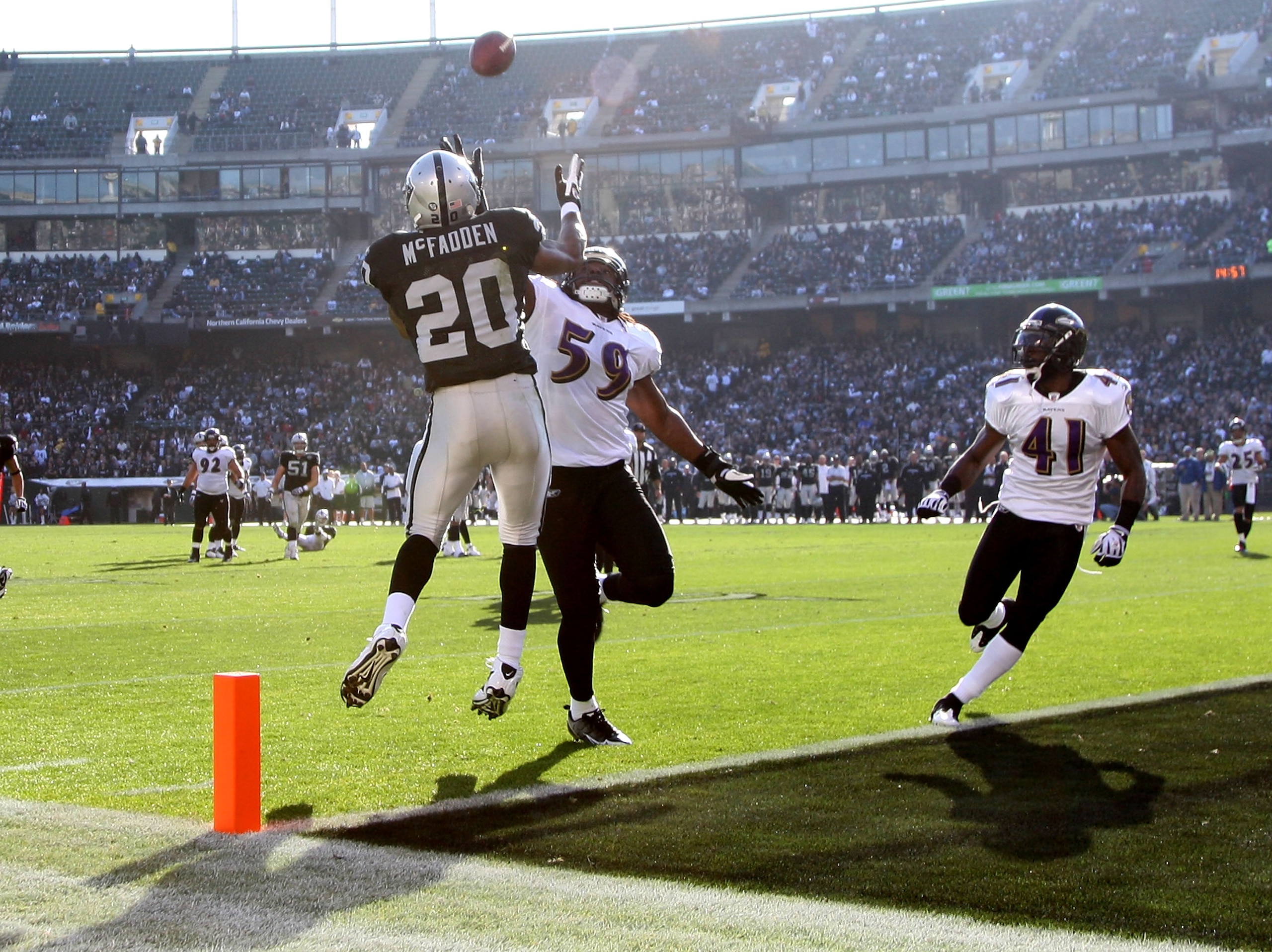 OAKLAND, CA - JANUARY 03:  Darren McFadden #20 of the Oakland Raiders can't hang on to a pass as Dannell Ellerbe #59 of the Baltimore Ravens defends during an NFL game at Oakland-Alameda County Coliseum on January 3, 2010 in Oakland, California.  (Photo b