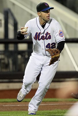 NEW YORK - APRIL 19:  David Wright #5 of the New York Mets fields the ball against the Chicago Cubs on April 19, 2010 at Citi Field in the Flushing neighborhood of the Queens borough of New York City. Players from both teams are wearing #42 in honor of fo