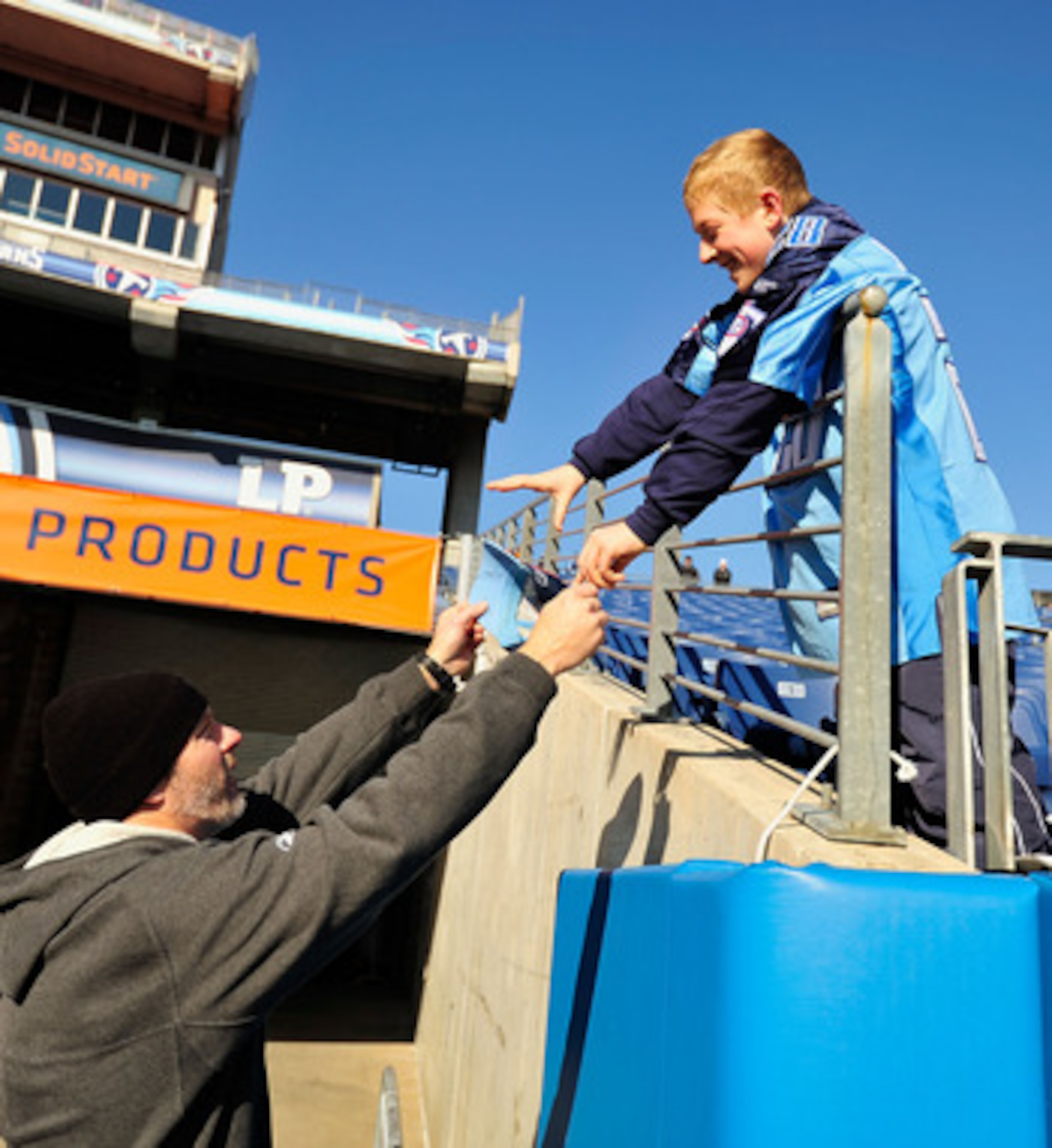 NASHVILLE, TN - DECEMBER 19:  Kerry Collins #5 of the Tennessee Titans signs an autograph for a fan before a game against the Houston Texans at LP Field on December 19, 2010 in Nashville, Tennessee.  (Photo by Grant Halverson/Getty Images)