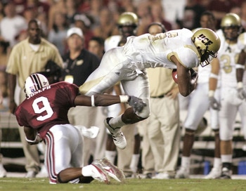 COLUMBIA, SC - SEPTEMBER 1: Jonathan Joseph #9 of the South Carolina Gamecocks trips Brandon Marshall #9 of the University of Central Florida Golden Knights during a game on September 1, 2005 at Williams-Brice Stadium in Columbia, South Carolina. (Photo COLUMBIA, SC - SEPTEMBER 1: Jonathan Joseph #9 of the South Carolina Gamecocks trips Brandon Marshall #9 of the University of Central Florida Golden Knights during a game on September 1, 2005 at Williams-Brice Stadium in Columbia, South Carolina. (Photo