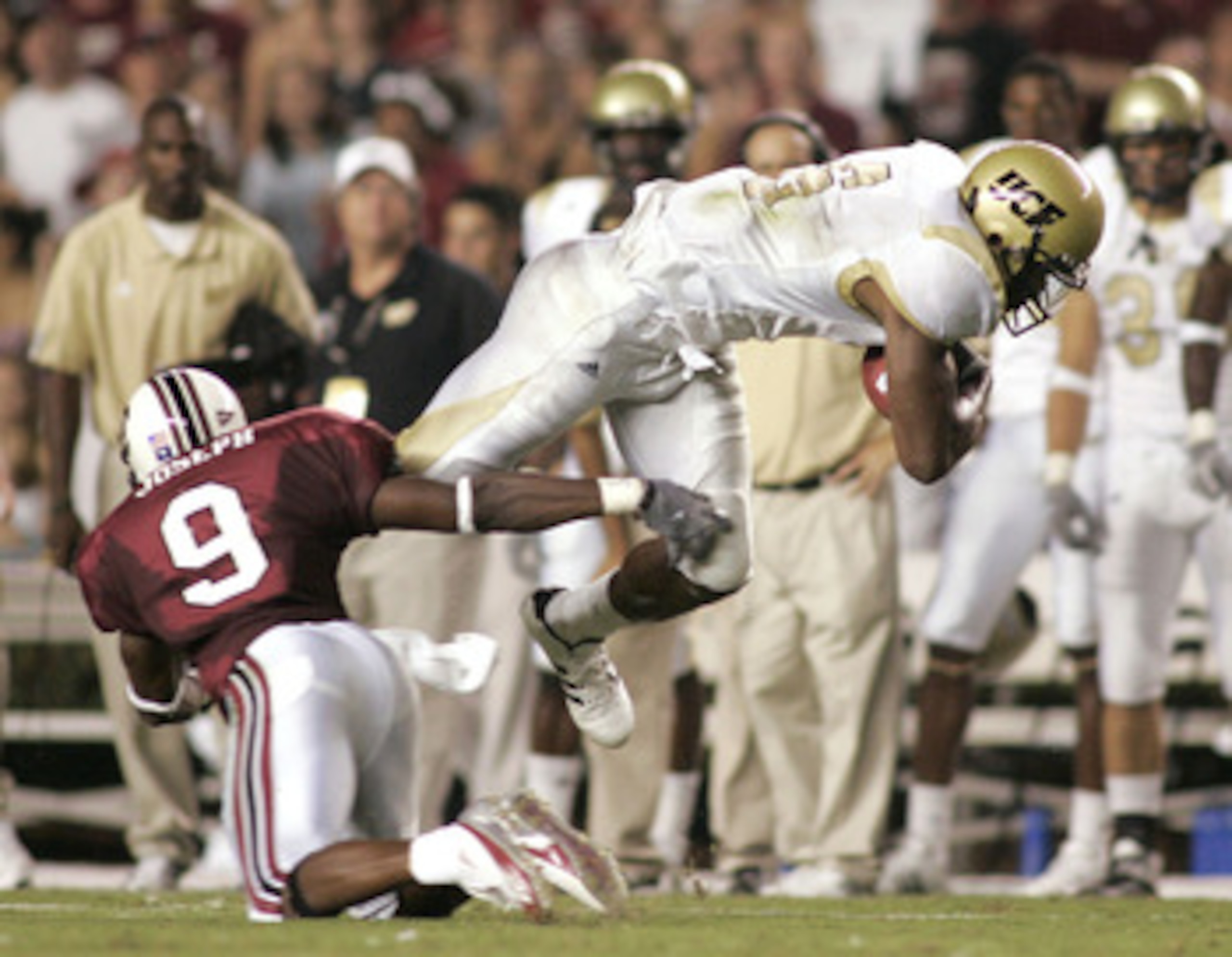 COLUMBIA, SC - SEPTEMBER 1:  Jonathan Joseph #9 of the South Carolina Gamecocks trips Brandon Marshall #9 of the University of Central Florida Golden Knights during a game on September 1, 2005 at Williams-Brice Stadium in Columbia, South Carolina.  (Photo