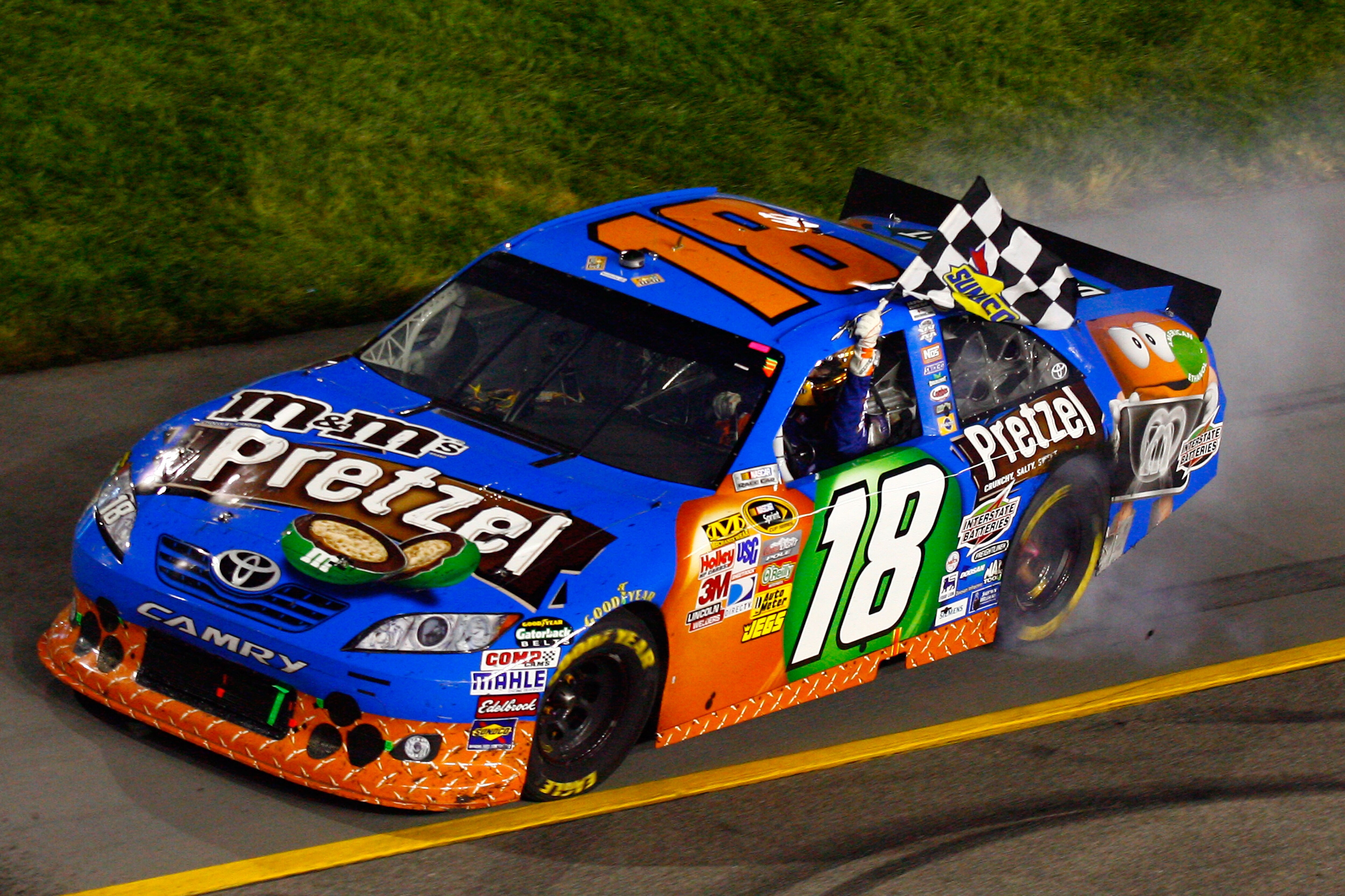 RICHMOND, VA - APRIL 30:  Kyle Busch, driver of the #18 M&M's Pretzel Toyota, celebrates after winning the NASCAR Sprint Cup Series Crown Royal Presents The Matthew & Daniel Hansen 400 at Richmond International Raceway on April 30, 2011 in Richmond, Virgi