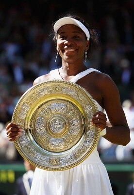 LONDON - JULY 05:  Venus Williams of United States celebrates winning the Championship trophy during the women's singles Final match against Serena Williams of United States on day twelve of the Wimbledon Lawn Tennis Championships at the All England Lawn 