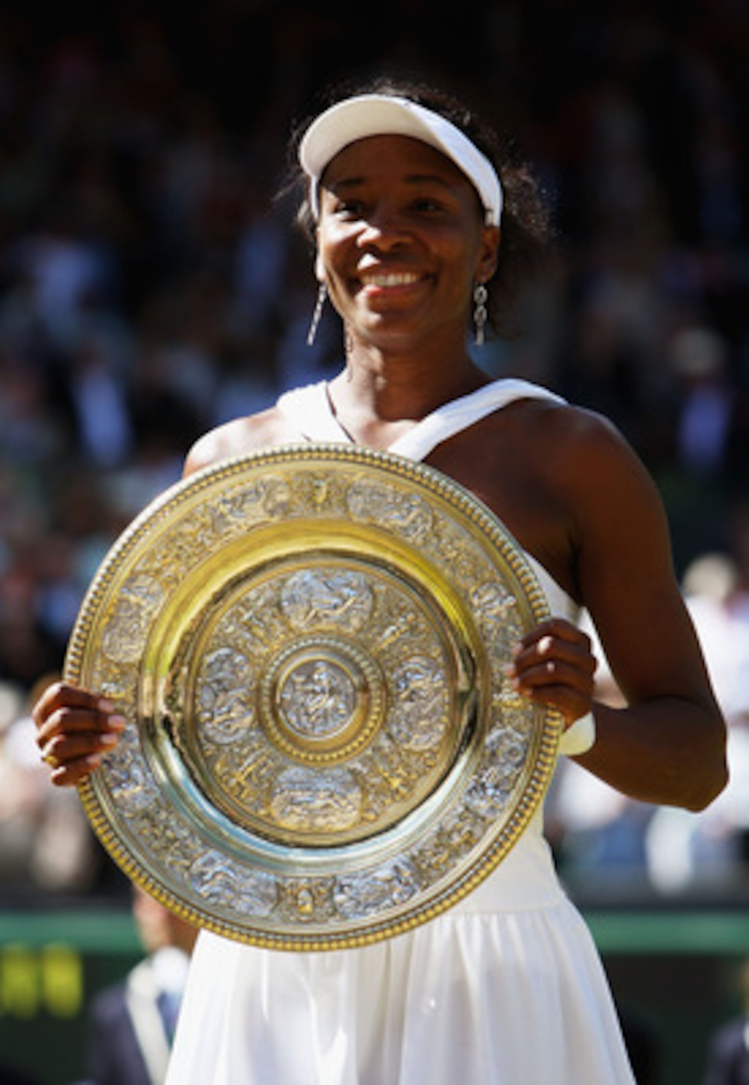 LONDON - JULY 05:  Venus Williams of United States celebrates winning the Championship trophy during the women's singles Final match against Serena Williams of United States on day twelve of the Wimbledon Lawn Tennis Championships at the All England Lawn 