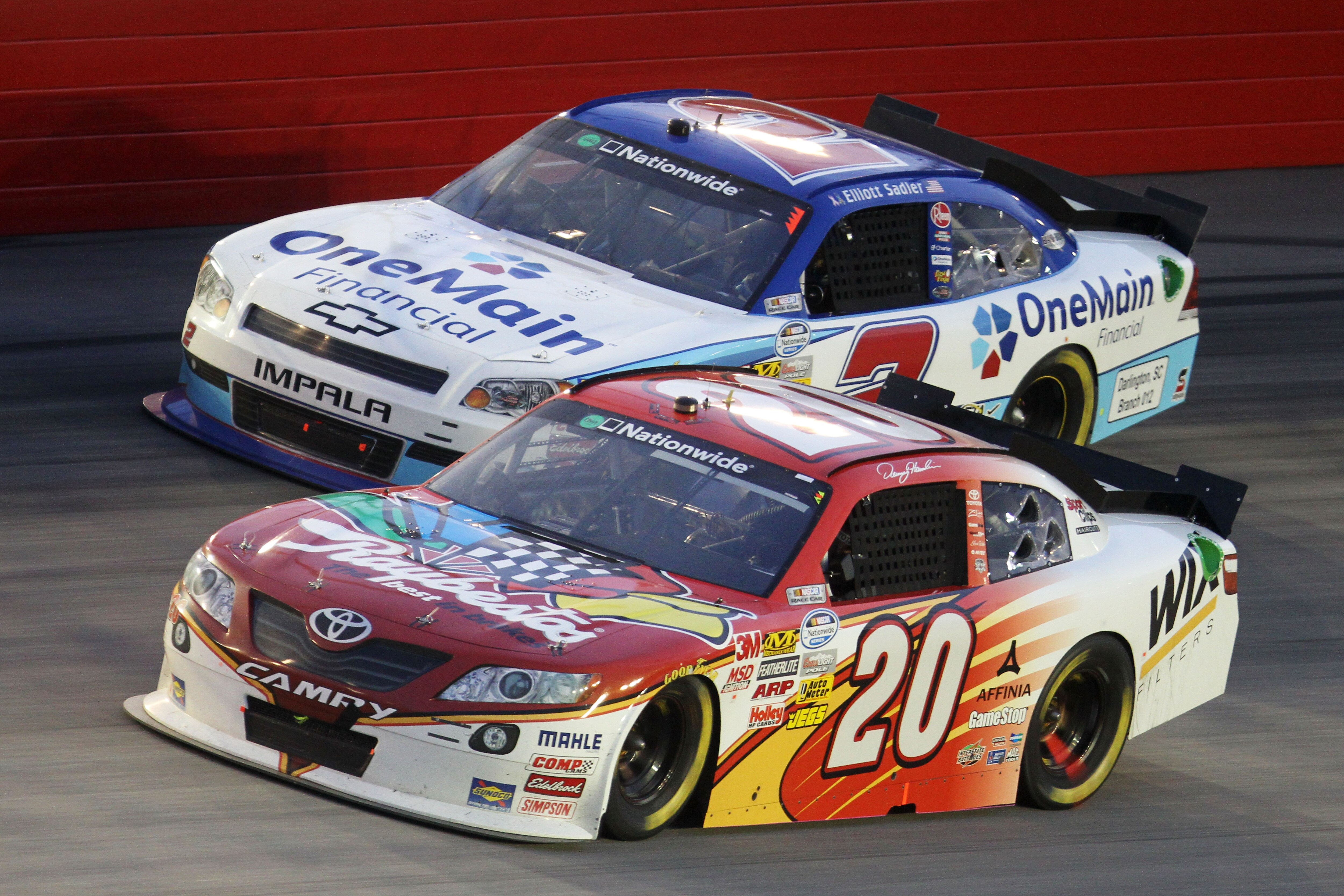 DARLINGTON, SC - MAY 06:  Denny Hamlin, driver of the #20 Raybestos Toyota, races Elliott Sadler, driver of the #2 OneMain Financial Chevrolet, during the NASCAR Nationwide Series Royal Purple 200 at Darlington Raceway on May 6, 2011 in Darlington, South