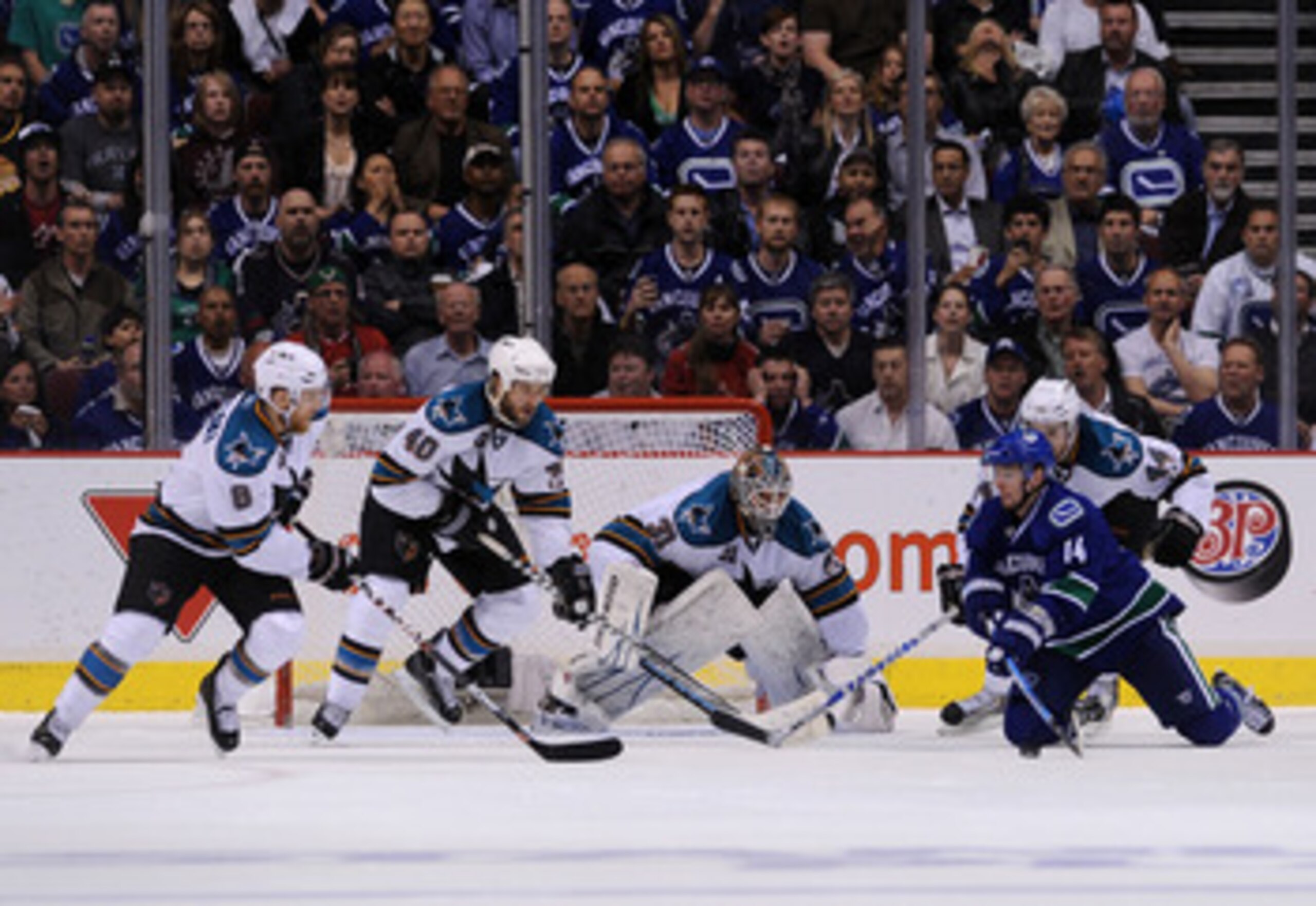 VANCOUVER, CANADA - MAY 24:  Joe Pavelski #8, Kent Huskins #40, goaltender Antti Niemi #31, and Marc-Edouard Vlasic #44 of the San Jose Sharks defend the play of Alex Burrows #14 of the Vancouver Canucks in Game Five of the Western Conference Finals durin