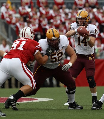 MADISON, WI - SEPTEMBER 18: Steven Threet #14 of the Arizona State Sun Devils takes the snap as teammates Garth Gerhart #52 and Mike Marcisz #70 move to block against Jordan Kohout #91 and Eathan Hemer #87 of the Wisconsin Badgers at Camp Randall Stadium