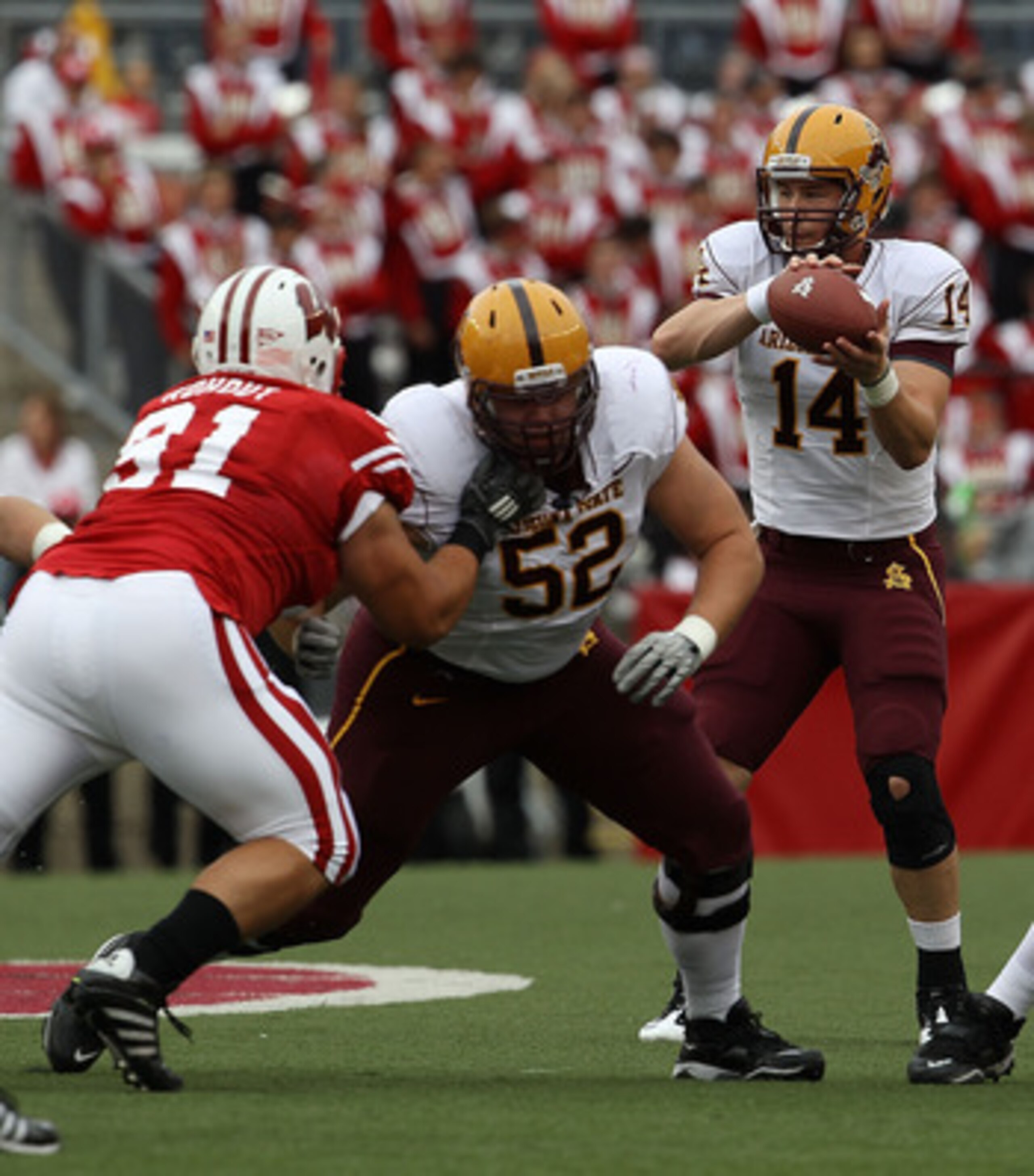 MADISON, WI - SEPTEMBER 18: Steven Threet #14 of the Arizona State Sun Devils takes the snap as teammates Garth Gerhart #52 and Mike Marcisz #70 move to block against Jordan Kohout #91 and Eathan Hemer #87 of the Wisconsin Badgers at Camp Randall Stadium