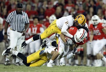 TUCSON, AZ - DECEMBER 02:  Runningback Keola Antolin #2 of the Arizona Wildcats rushes the football against Eddie Elder #2 of the Arizona State Sun Devils during the college football game at Arizona Stadium on December 2, 2010 in Tucson, Arizona.  (Photo