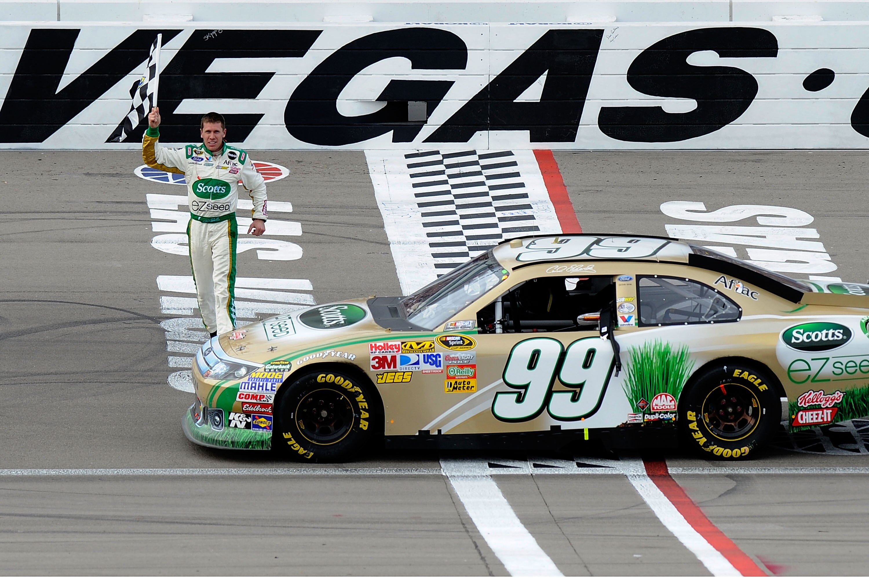 LAS VEGAS, NV - MARCH 06:  Carl Edwards, driver of the #99 Scotts/Kellogg's Ford, celebrates after winning the NASCAR Sprint Cup Series Kobalt Tools 400 at Las Vegas Motor Speedway on March 6, 2011 in Las Vegas, Nevada.  (Photo by John Harrelson/Getty Ima