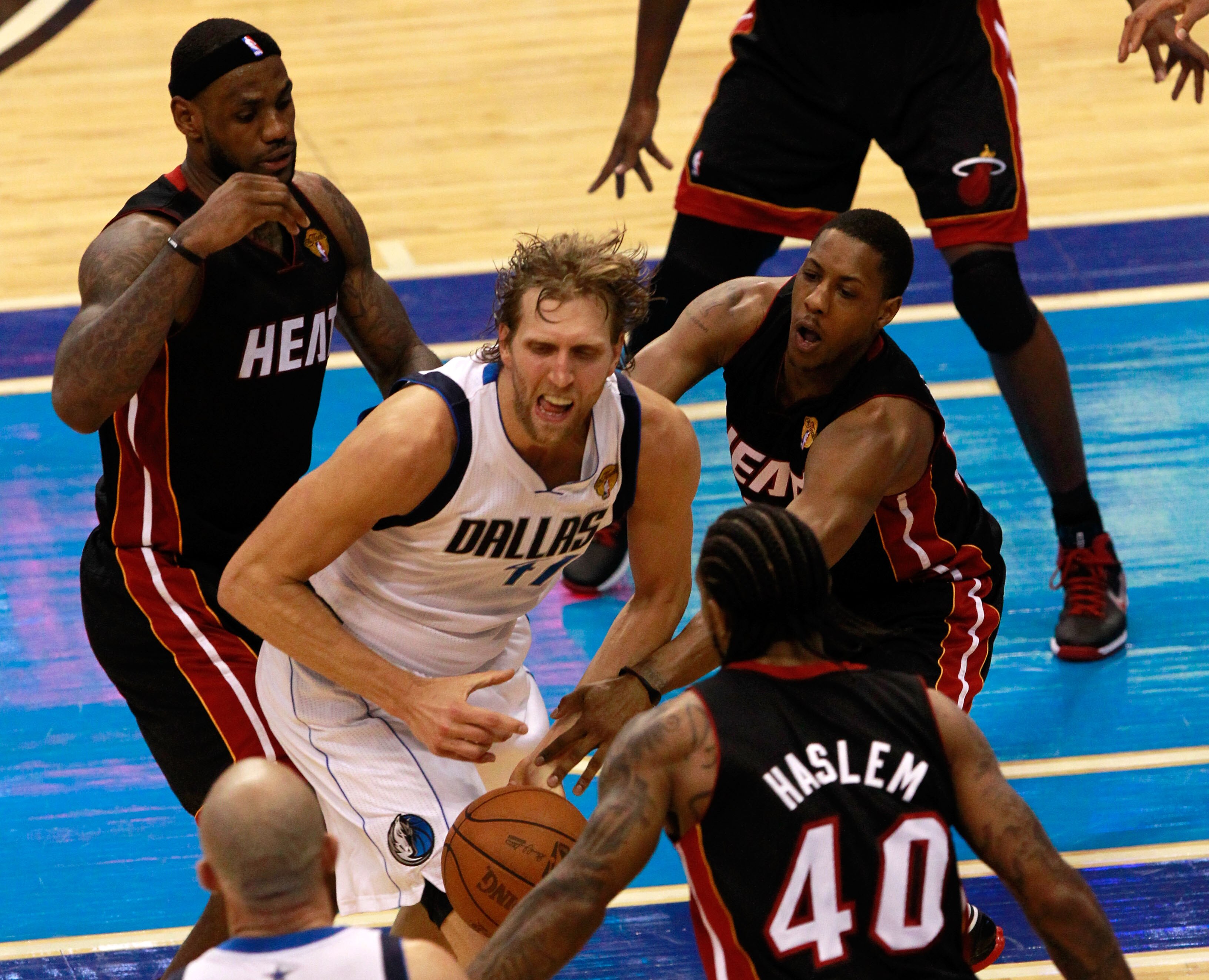 DALLAS, TX - JUNE 09: LeBron James #6 (L), Mario Chalmers #15 and Udonis Haslem #40 of the Miami Heat defend against Dirk Nowitzki #41 of the Dallas Mavericks in Game Five of the 2011 NBA Finals at American Airlines Center on June 9, 2011 in Dallas, Texas