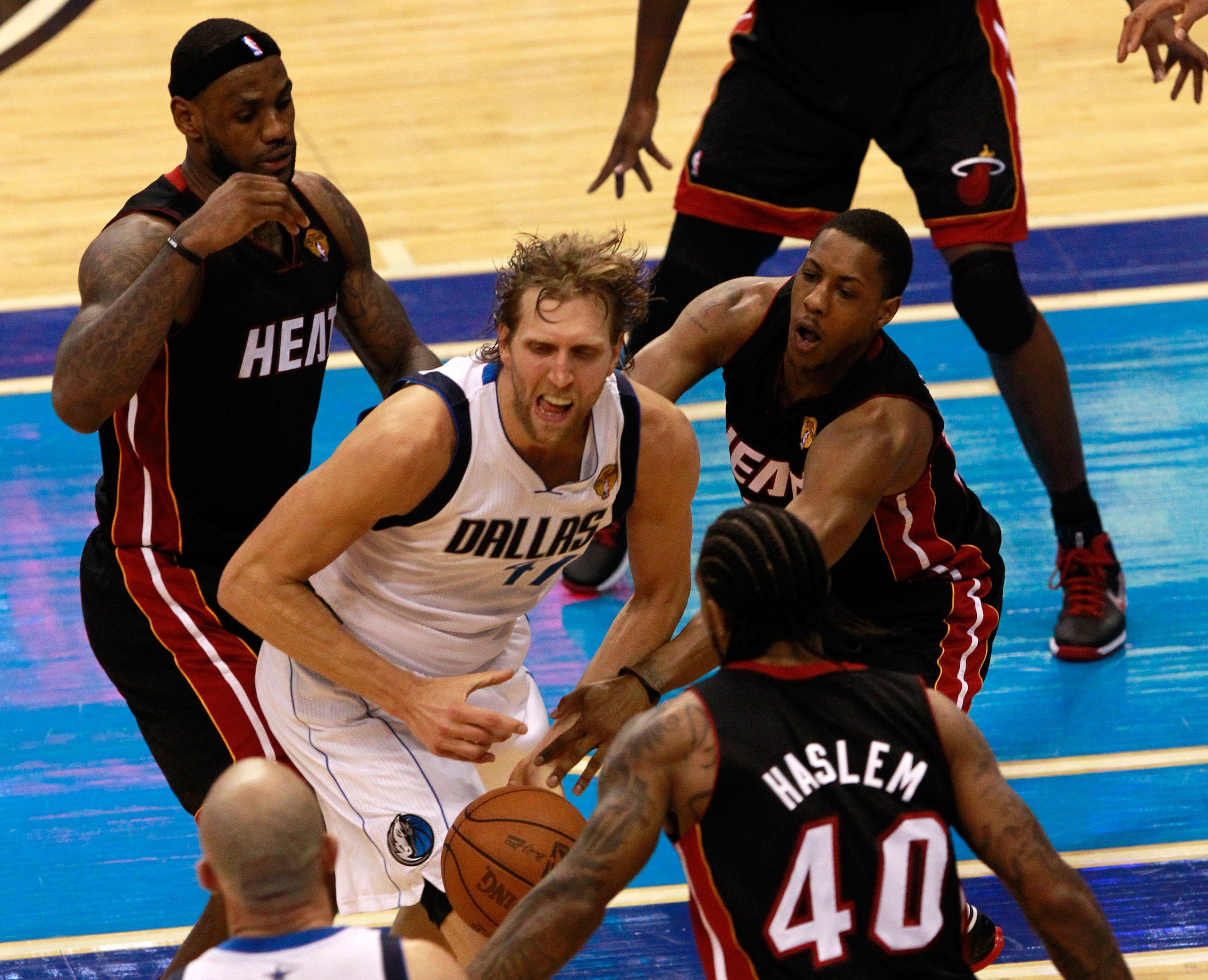 DALLAS, TX - JUNE 09: LeBron James #6 (L), Mario Chalmers #15 and Udonis Haslem #40 of the Miami Heat defend against Dirk Nowitzki #41 of the Dallas Mavericks in Game Five of the 2011 NBA Finals at American Airlines Center on June 9, 2011 in Dallas, Texas