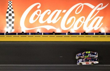 CONCORD, NC - MAY 29:  Dale Earnhardt Jr., driver of the #88 National Guard/Amp Energy Chevrolet, and Jimmie Johnson, driver of the #48 Lowe's Summer Salute Chevrolet, race side by side during the NASCAR Sprint Cup Series Coca-Cola 600 at Charlotte Motor 