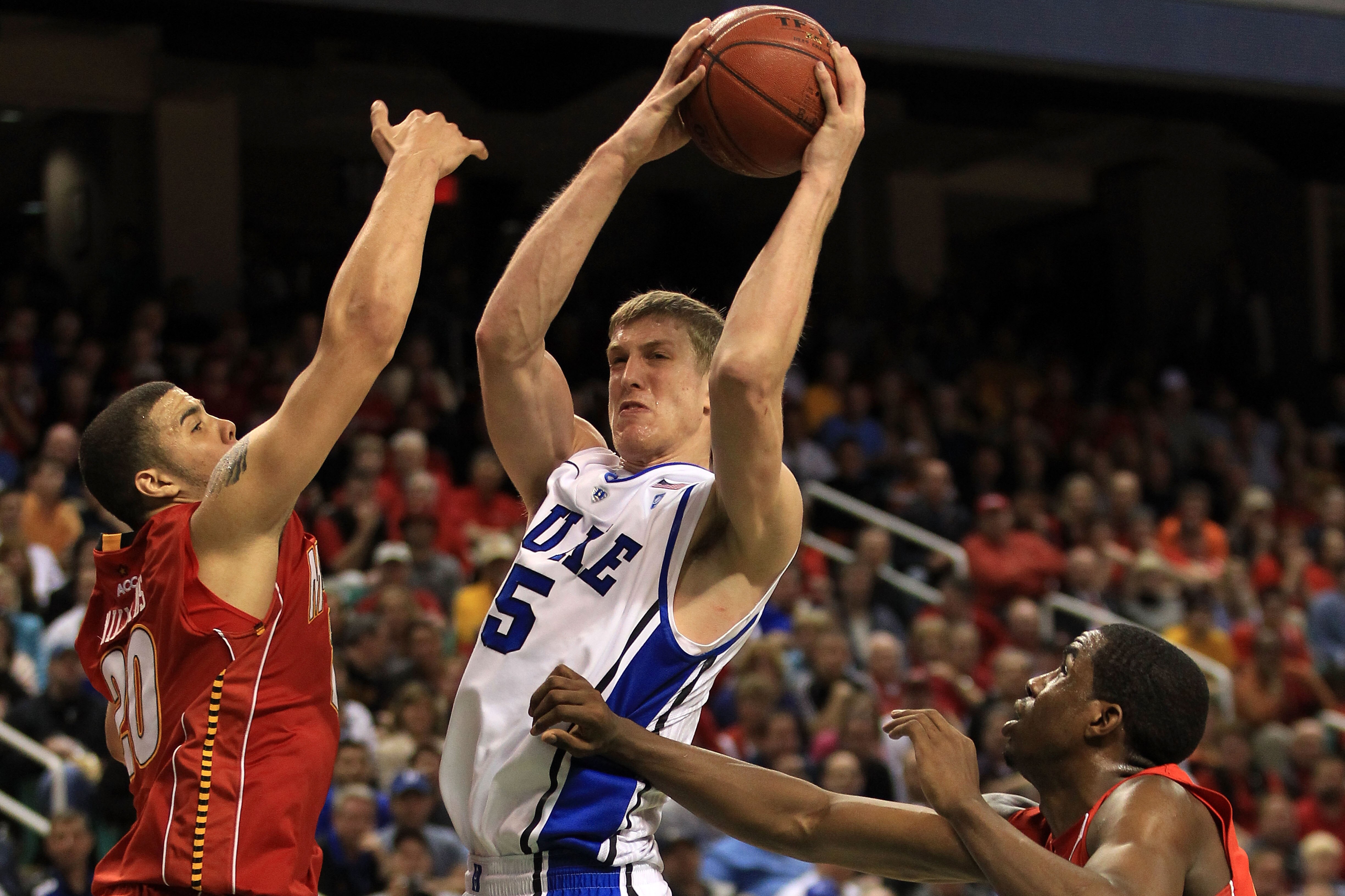 GREENSBORO, NC - MARCH 11: Mason Plumlee #5 of the Duke Blue Devils shoots against Jordan Williams #20 and Dino Gregory #33 of the Maryland Terrapins during the second half in the quarterfinals of the 2011 ACC men's basketball tournament at the Greensbor GREENSBORO, NC - MARCH 11: Mason Plumlee #5 of the Duke Blue Devils shoots against Jordan Williams #20 and Dino Gregory #33 of the Maryland Terrapins during the second half in the quarterfinals of the 2011 ACC men's basketball tournament at the Greensbor