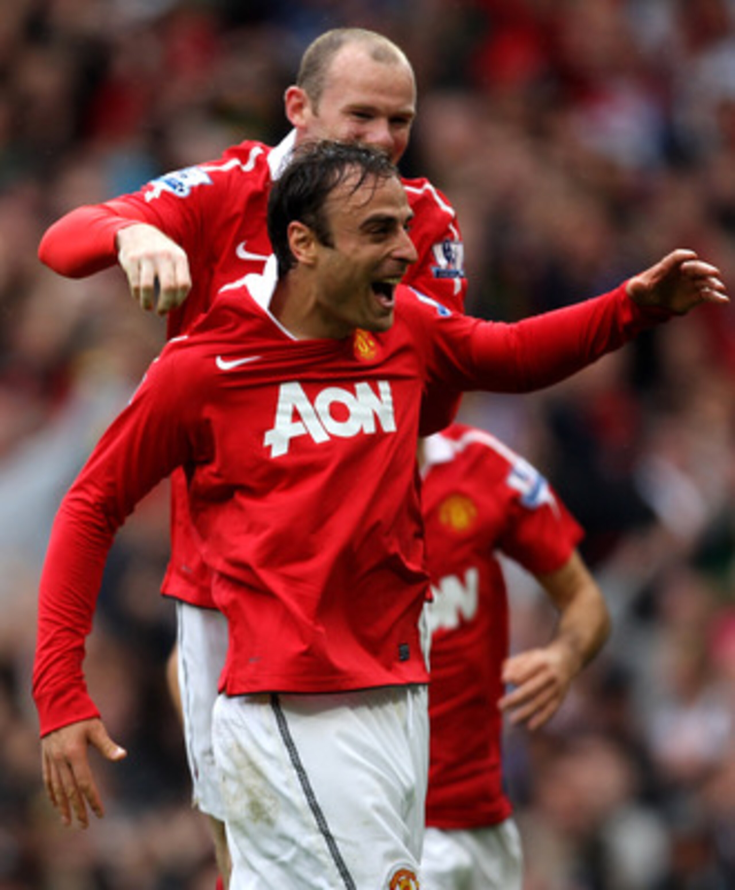 MANCHESTER, ENGLAND - SEPTEMBER 19:  Dimitar Berbatov of Manchester United celebrates scoring his team's second goal with team mate Wayne Rooney during the Barclays Premier League match between Manchester United and Liverpool at Old Trafford on September 