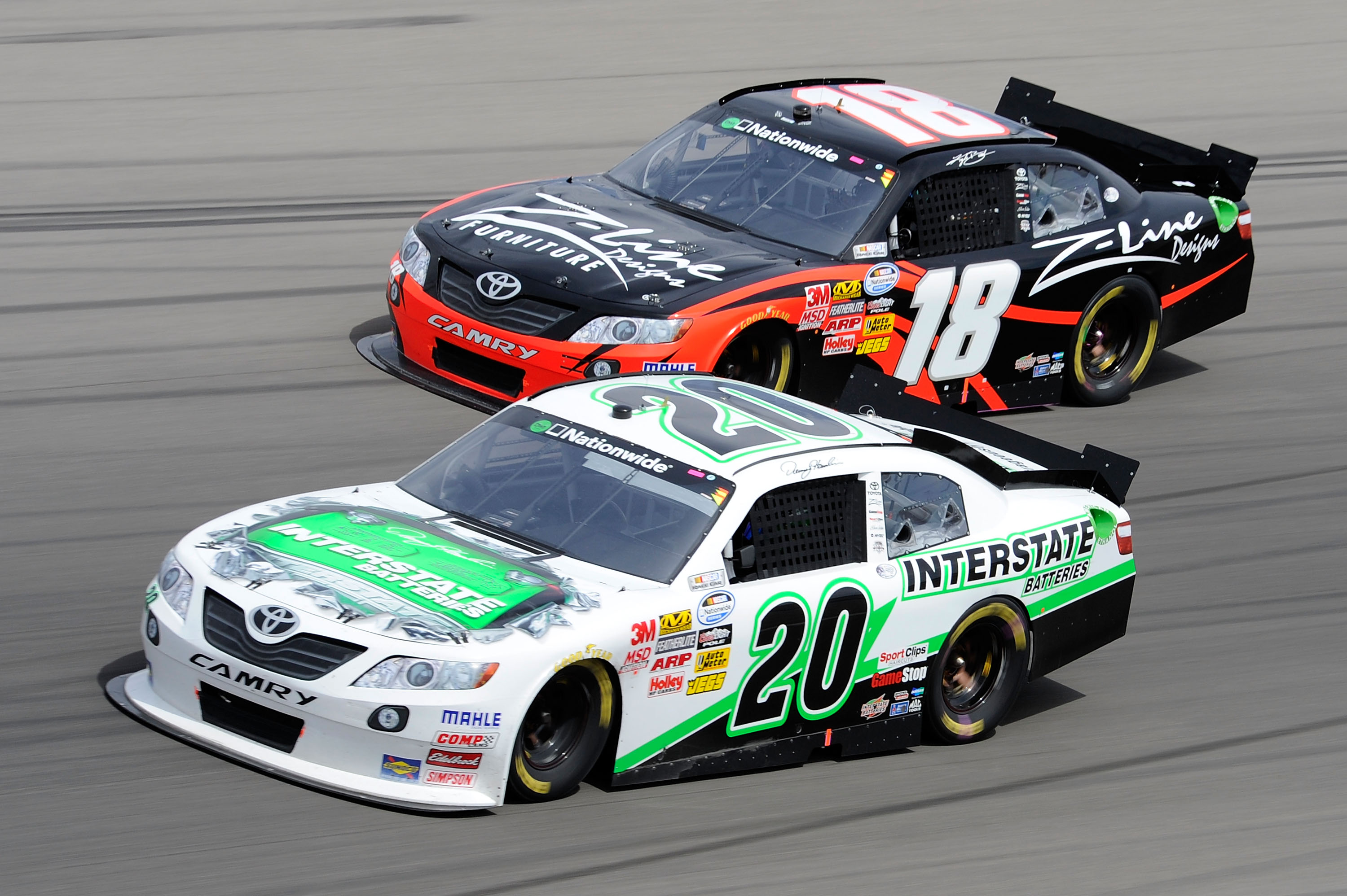 LAS VEGAS, NV - MARCH 05:  Denny Hamlin, driver of the #20 Interstate Batteries Toyota, and Kyle Busch, driver of the #18 Z-Line Designs Toyota, race side by side during the NASCAR Nationwide Series Sam's Town 300 at Las Vegas Motor Speedway on March 5, 2