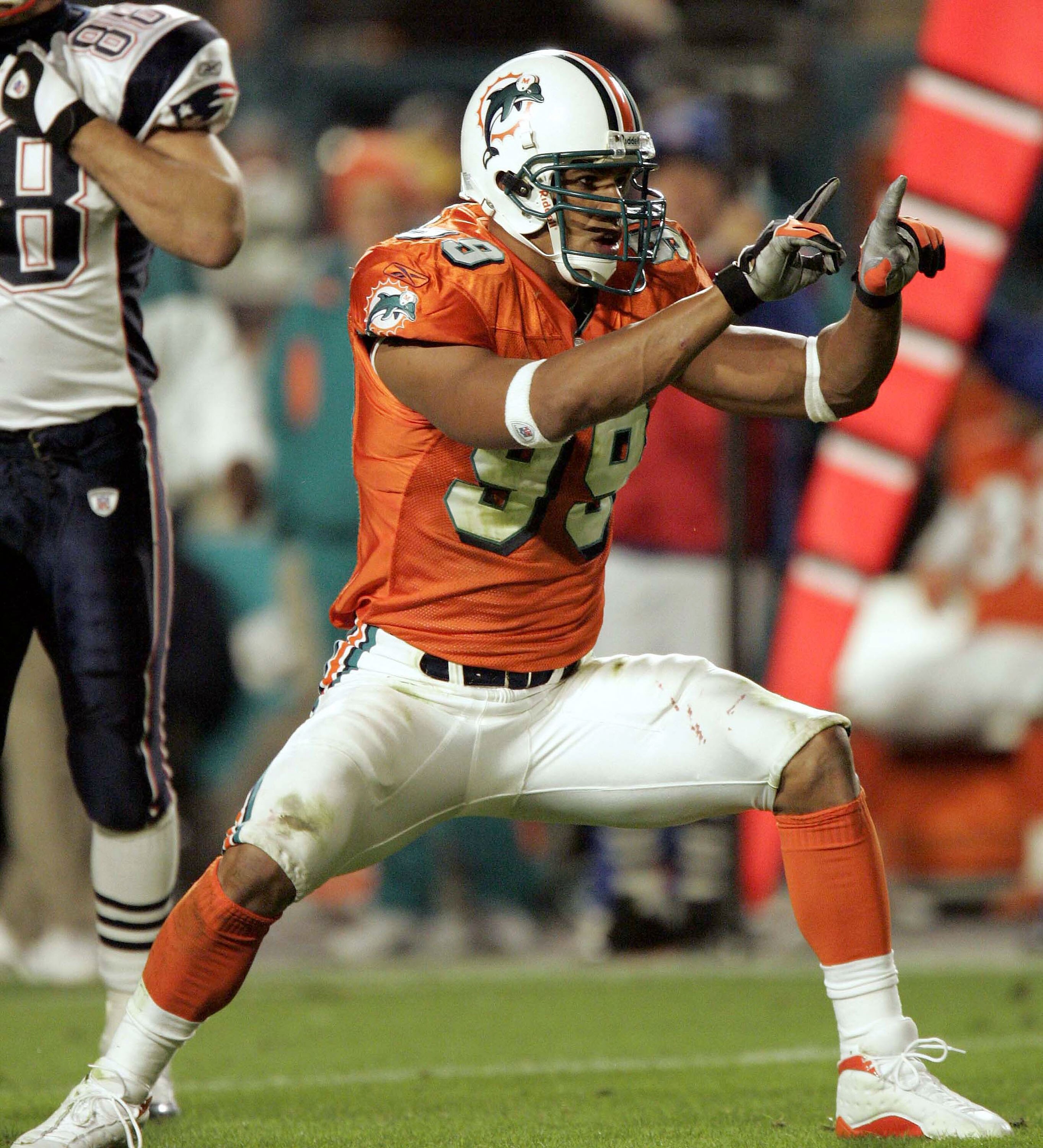 MIAMI - DECEMBER 20:  Defensive end Jason Taylor #99 of the Miami Dolphins celebrates a sack of quarterback Tom Brady #12 of the New England Patriots in the second quarter on December 20, 2004 at Pro Player Stadium in Miami, Florida.  (Photo by Eliot J. S