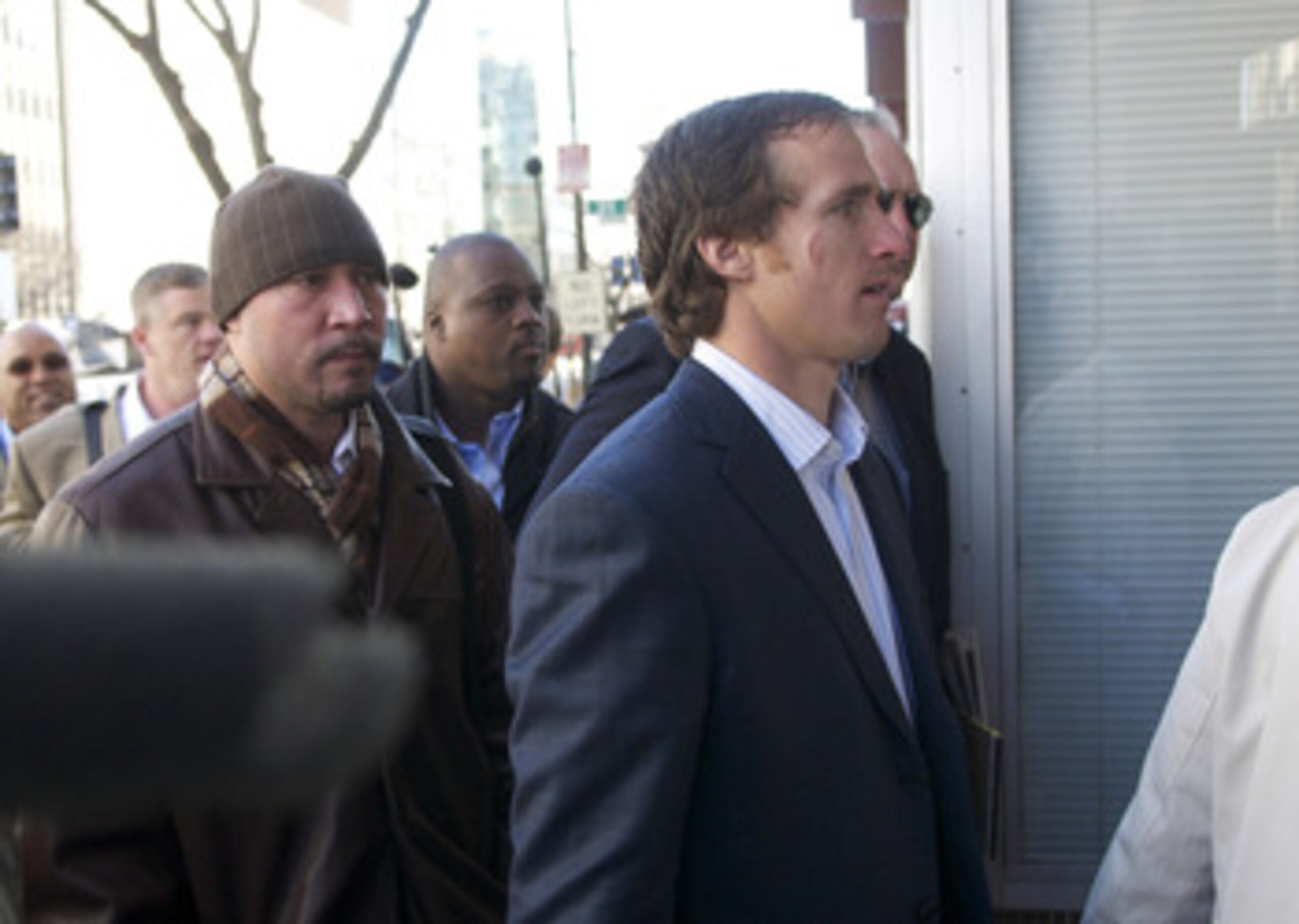 WASHINGTON, DC - MARCH 03:  New Orleans Saints' Drew Brees (R), a member of the NFL Players Association executive committee, makes his way into the Federal Mediation and Conciliation Service building for the NFL labor negotiations on March 3, 2011 in Wash