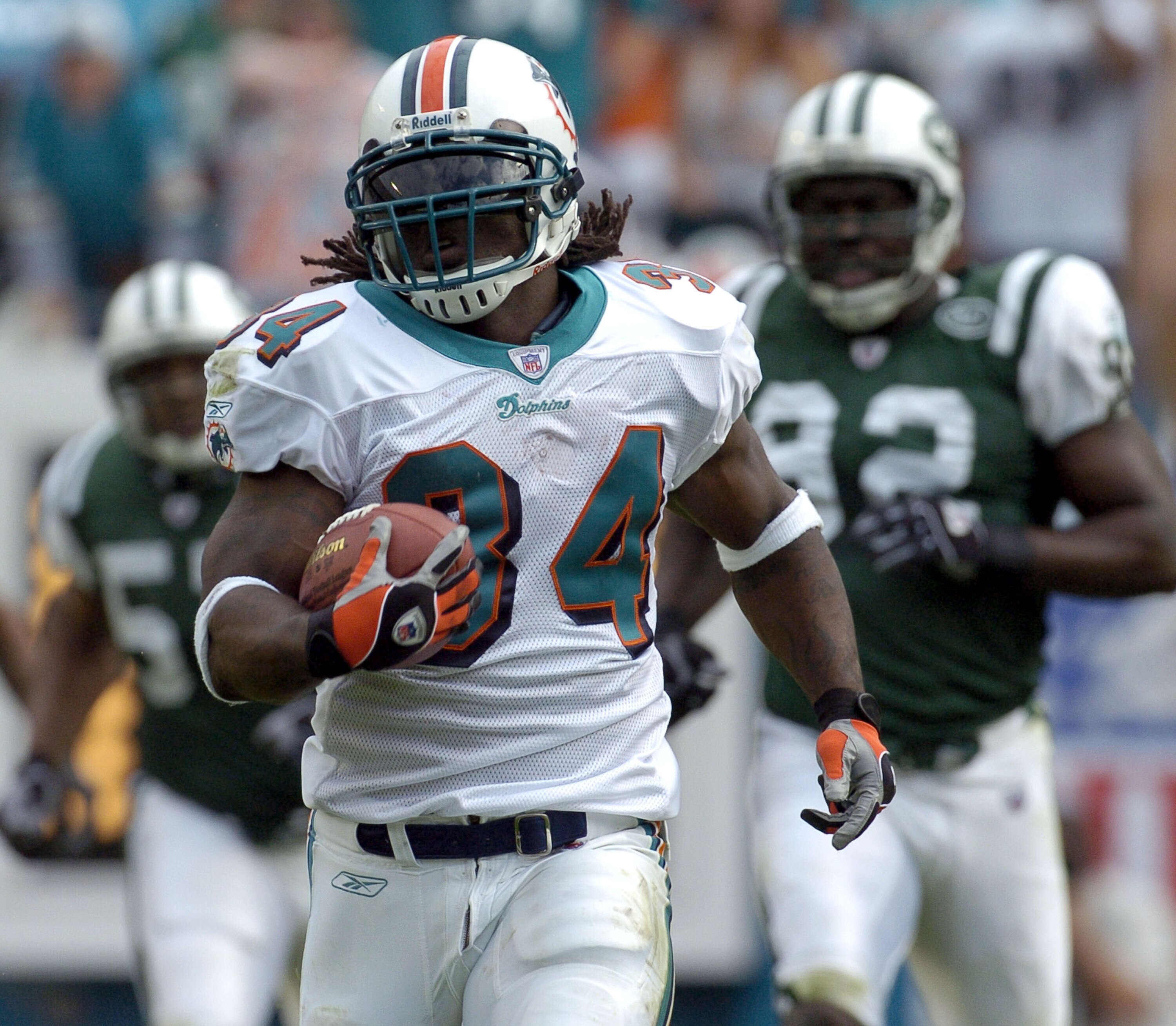 Miami Dolphins running back  Ricky Williams  rushes to midfield  December 28, 2003 at Pro Player Stadium, Miami, Florida.  Williams scored a touchdown and the Dolphins defeated the New York Jets 23 - 21.  (Photo by Al Messerschmidt/Getty Images)
