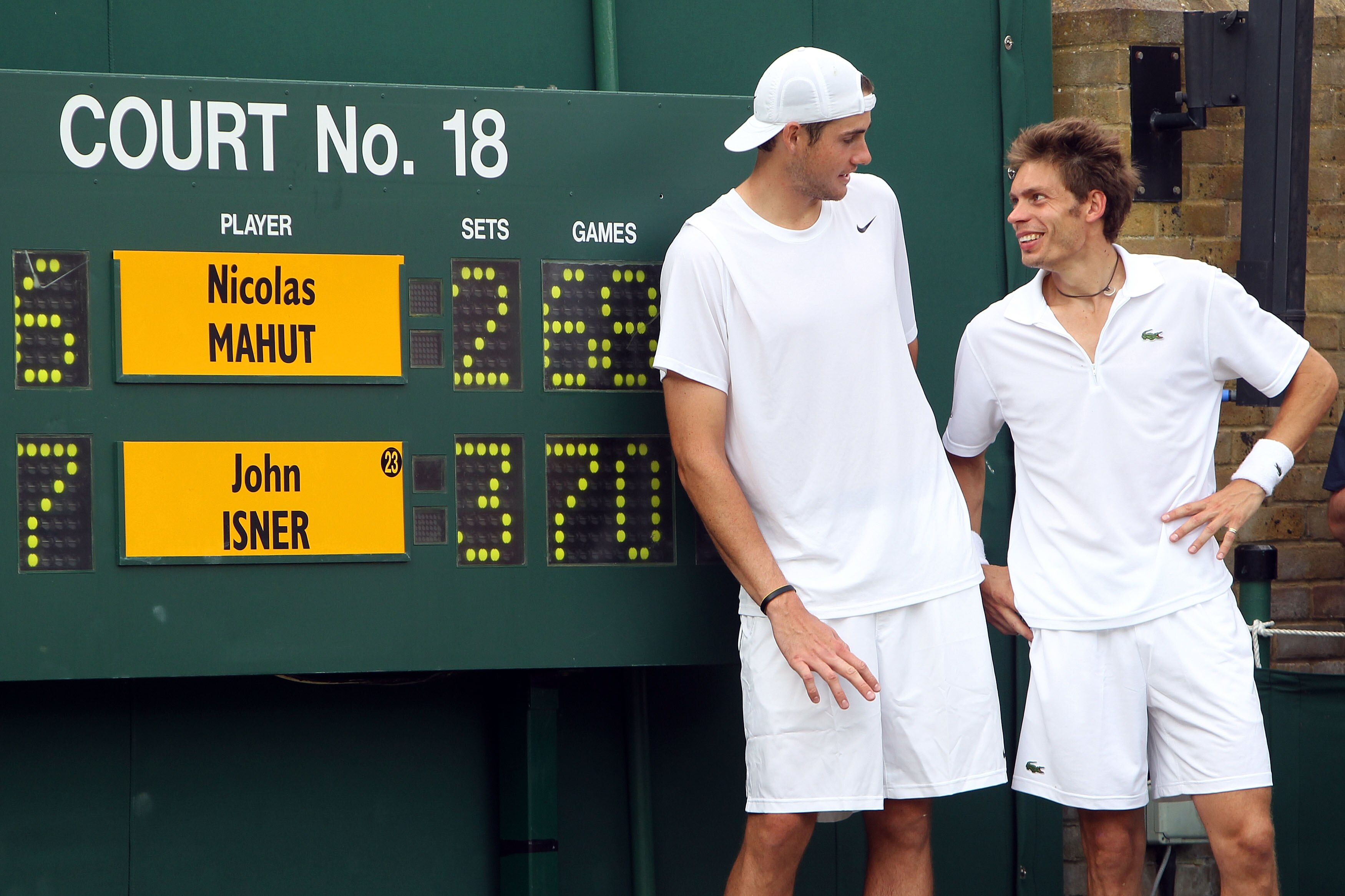 LONDON, ENGLAND - JUNE 24:  John Isner of USA (L) poses after winning on the third day of his first round match against Nicolas Mahut of France on Day Four of the Wimbledon Lawn Tennis Championships at the All England Lawn Tennis and Croquet Club on June