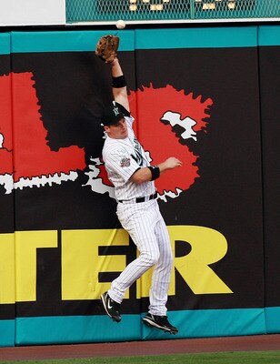 MIAMI - JUNE 22:  Left fielder Josh Willingham #14 of the Florida Marlins can't catch a first inning RBI double by Justin Morneau #33 of the Minnesota Twins during interleague play at Dolphin Stadium on June 22, 2007 in Miami, Florida. The Marlins defeate