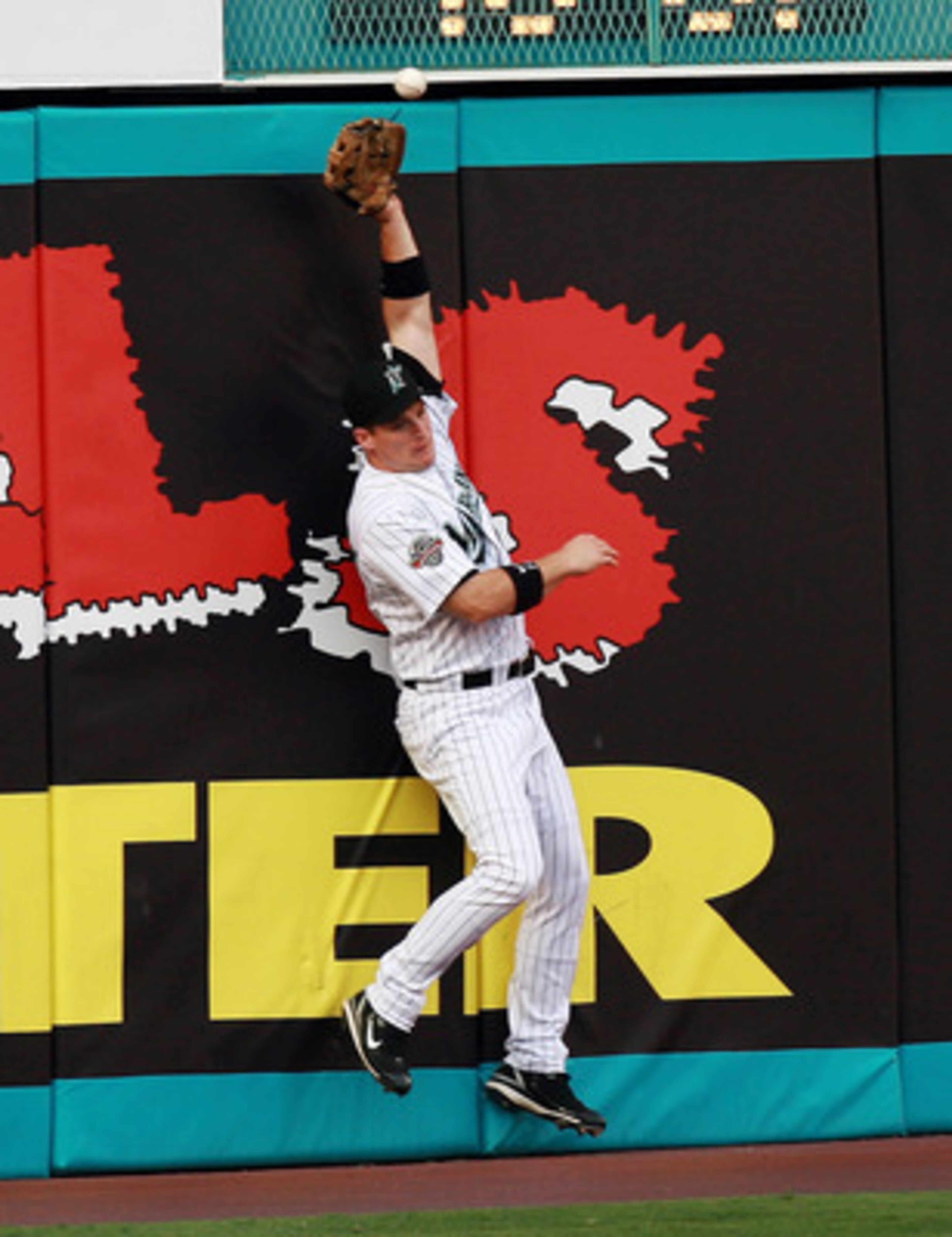 MIAMI - JUNE 22:  Left fielder Josh Willingham #14 of the Florida Marlins can't catch a first inning RBI double by Justin Morneau #33 of the Minnesota Twins during interleague play at Dolphin Stadium on June 22, 2007 in Miami, Florida. The Marlins defeate