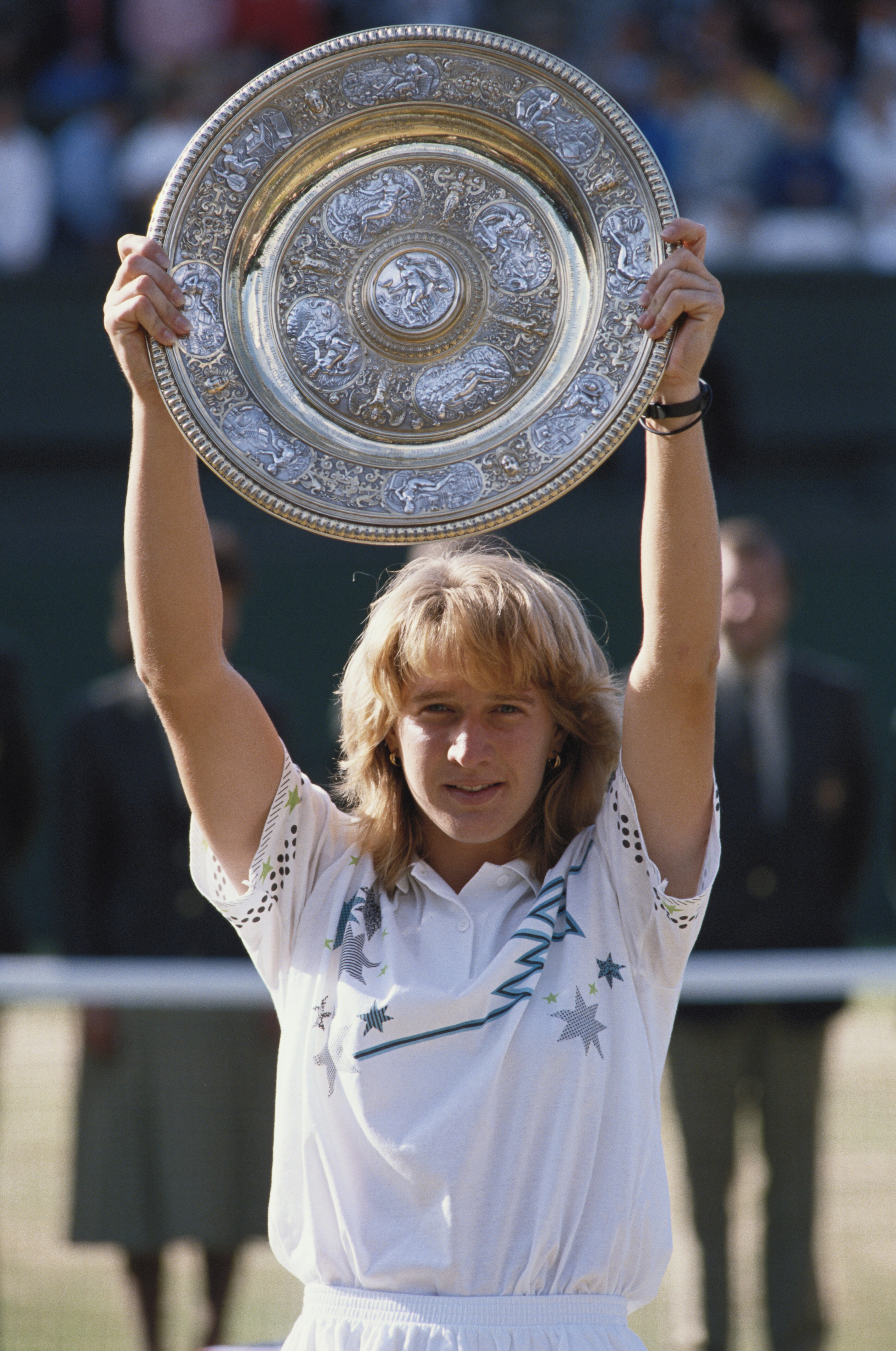 Steffi Graf of Germany holds aloft the Venus Rosewater Dish after defeating Martina Navratilova 5Â7, 6Â2, 6Â1in their Women's Singles Final match at the Wimbledon Lawn Tennis Championship on 3rd July 1988 at the All England Lawn Tennis and Croquet Club in