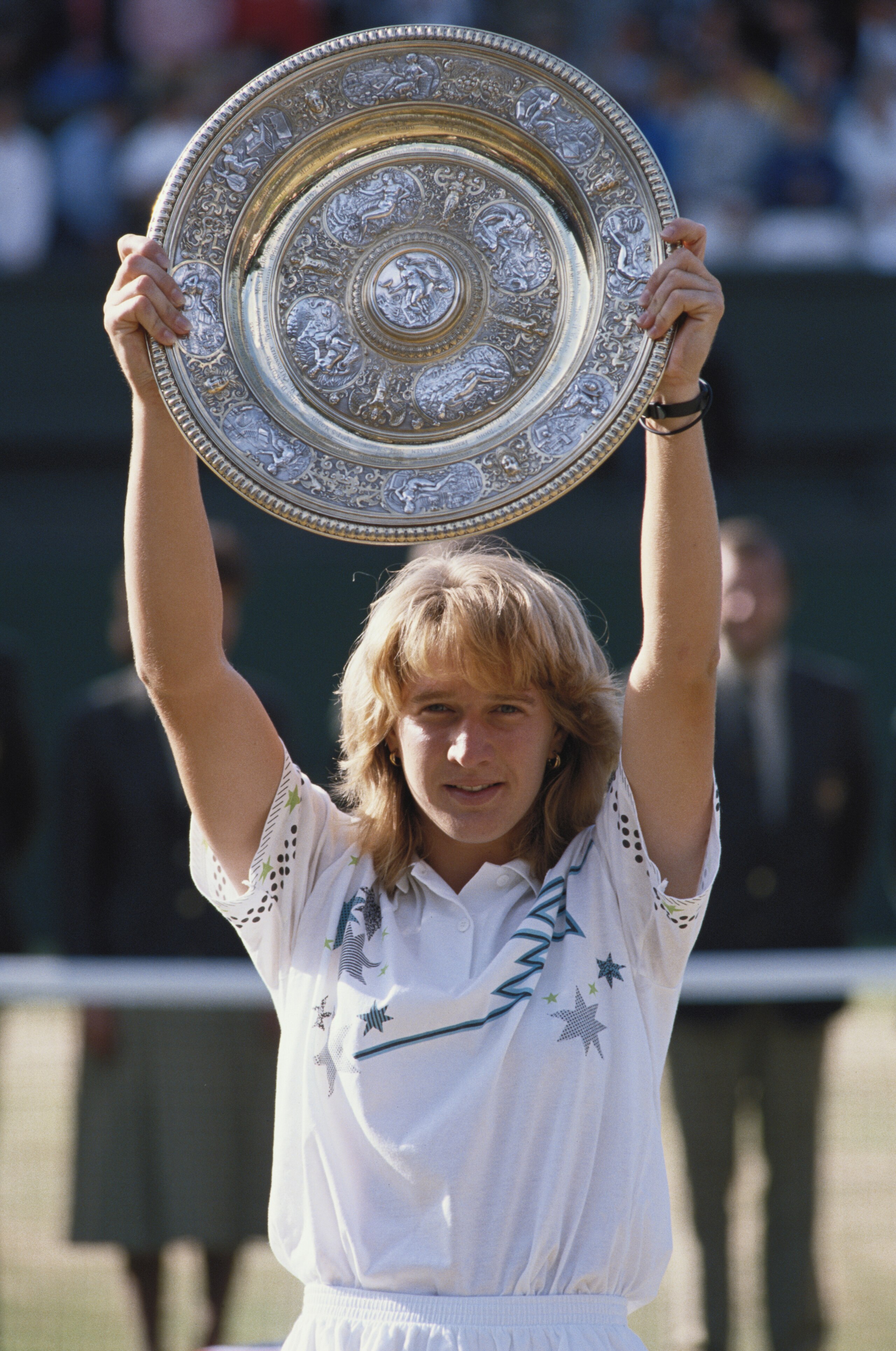 Steffi Graf of Germany holds aloft the Venus Rosewater Dish after defeating Martina Navratilova 5Â7, 6Â2, 6Â1in their Women's Singles Final match at the Wimbledon Lawn Tennis Championship on 3rd July 1988 at the All England Lawn Tennis and Croquet Club in