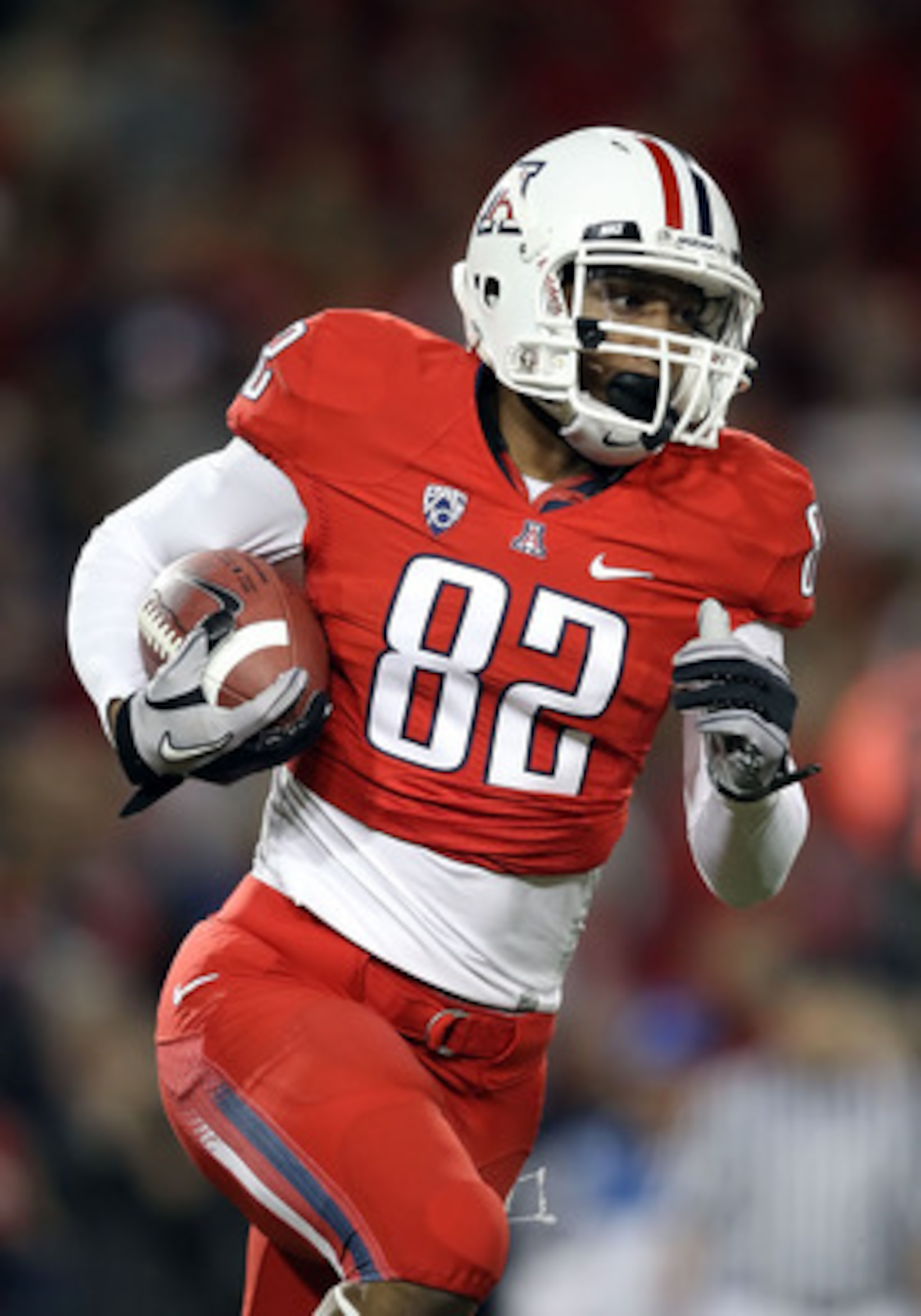 TUCSON, AZ - OCTOBER 23:  Wide receiver Juron Criner #82 of the Arizona Wildcats runs with the ball during the college football game against the Washington Huskies at Arizona Stadium on October 23, 2010 in Tucson, Arizona.   The Wildcats defeated the Husk