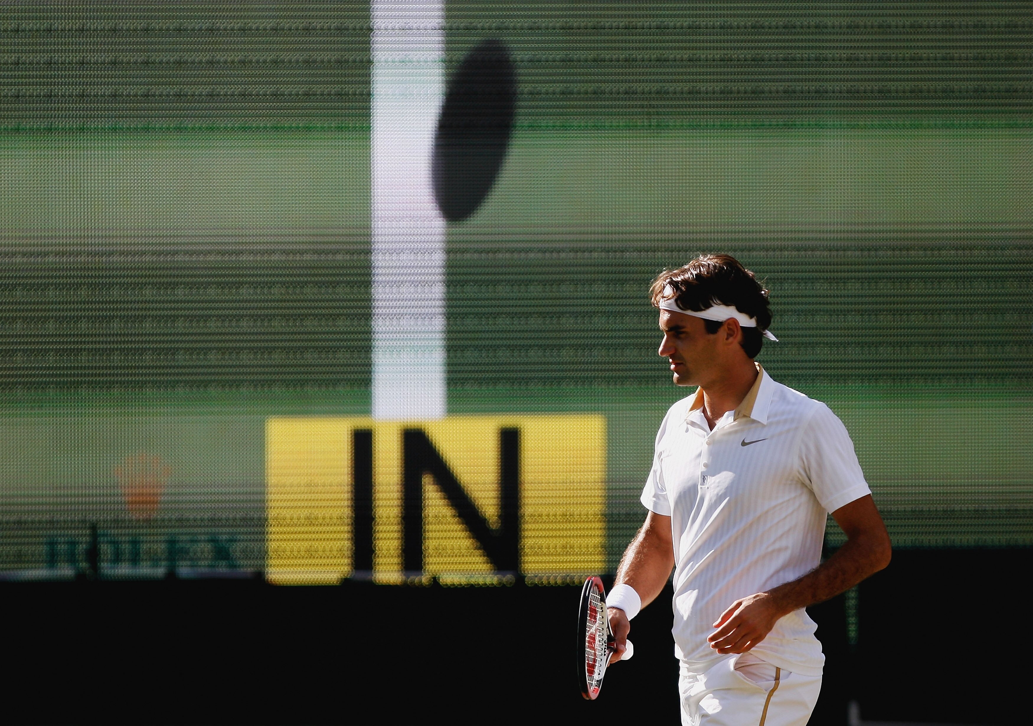 WIMBLEDON, ENGLAND - JULY 05:  Roger Federer of Switzerland looks on as hawkeye makes a call during the men's singles final match against Andy Roddick of USA on Day Thirteen of the Wimbledon Lawn Tennis Championships at the All England Lawn Tennis and Cro