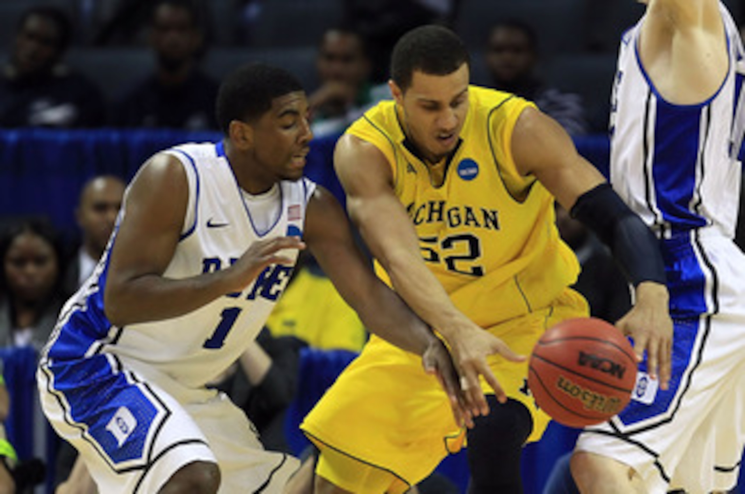 CHARLOTTE, NC - MARCH 20:  Kyrie Irving #1 of the Duke Blue Devils attempts to steal the ball from Jordan Morgan #52 of the Michigan Wolverines in the second half during the third round of the 2011 NCAA men's basketball tournament at Time Warner Cable Are