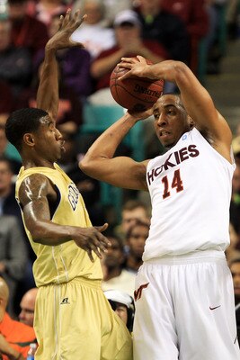 GREENSBORO, NC - MARCH 10:  Victor Davila #14 of the Virginia Tech Hokies  looks to pass against Iman Shumpert #1 of the Georgia Tech Yellow Jackets during the first half of the game in the first round of the 2011 ACC men's basketball tournament at the Gr