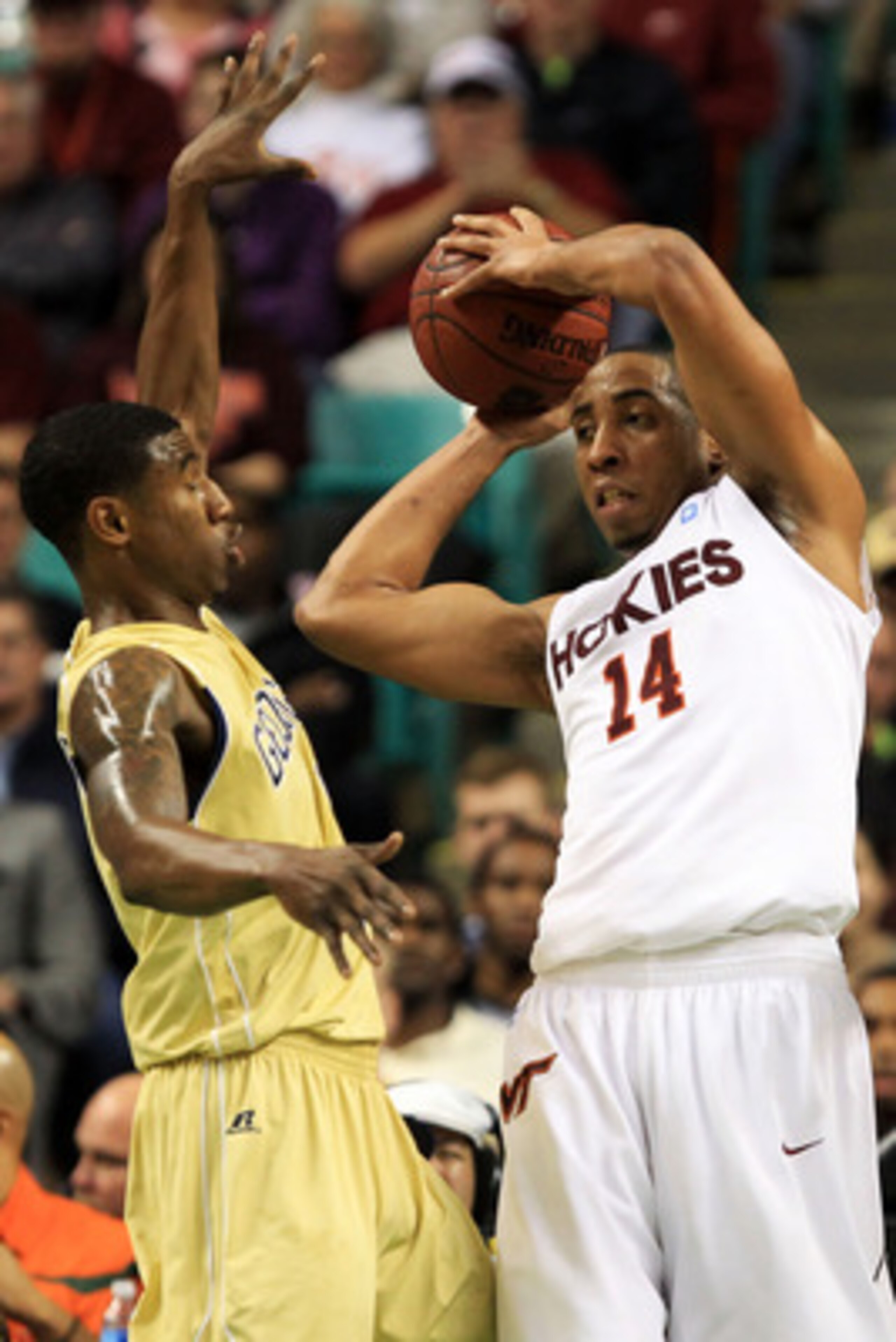 GREENSBORO, NC - MARCH 10:  Victor Davila #14 of the Virginia Tech Hokies  looks to pass against Iman Shumpert #1 of the Georgia Tech Yellow Jackets during the first half of the game in the first round of the 2011 ACC men's basketball tournament at the Gr